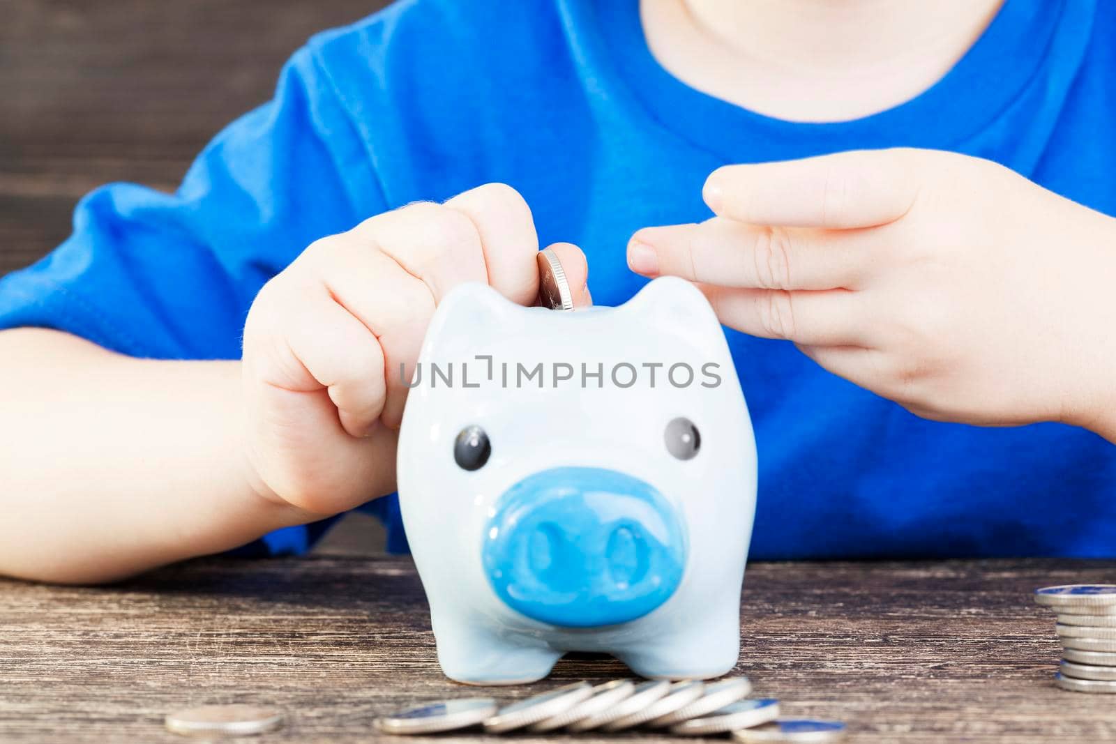 boy lays in his piggy bank by avq
