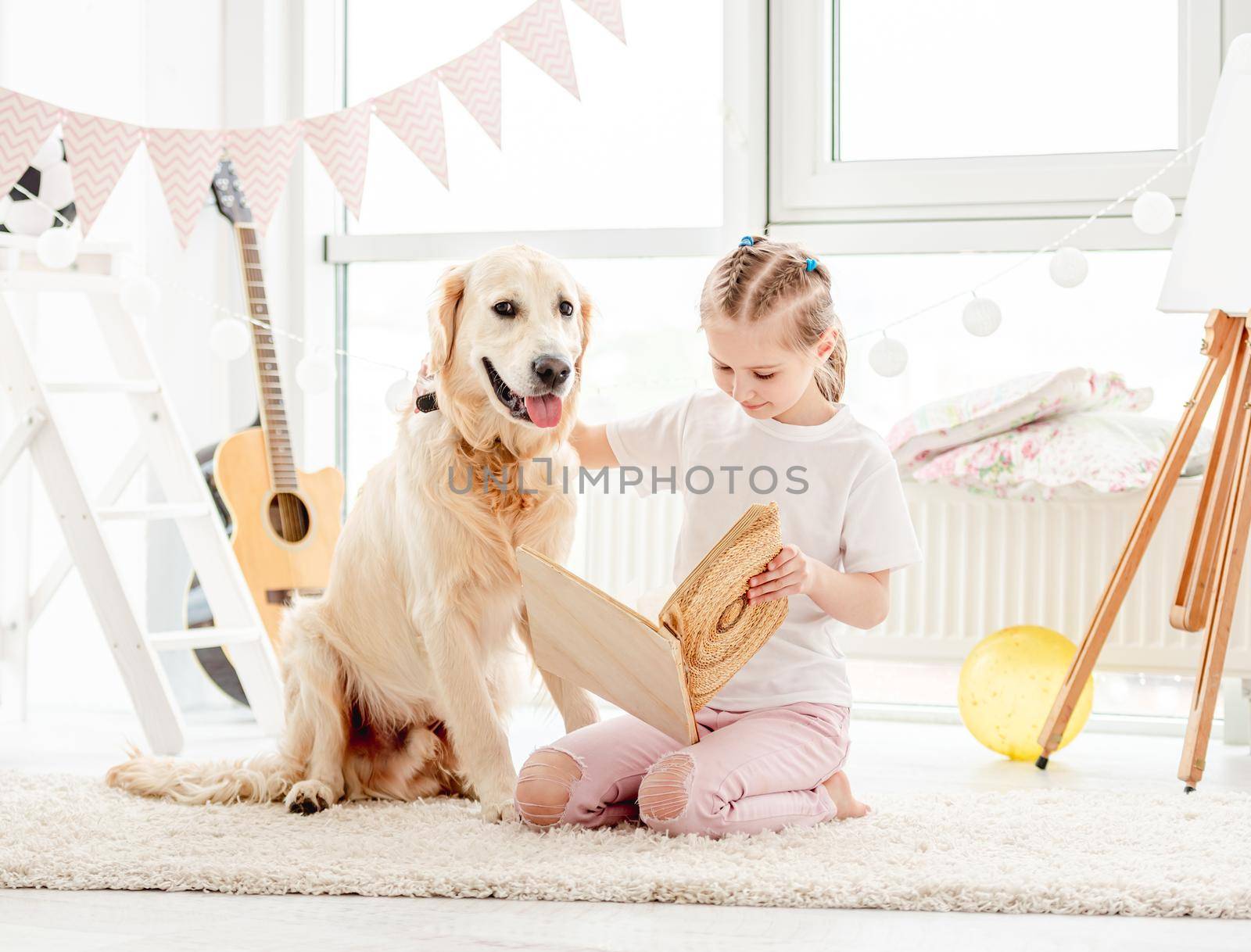 Cute little girl and dog reading by tan4ikk1