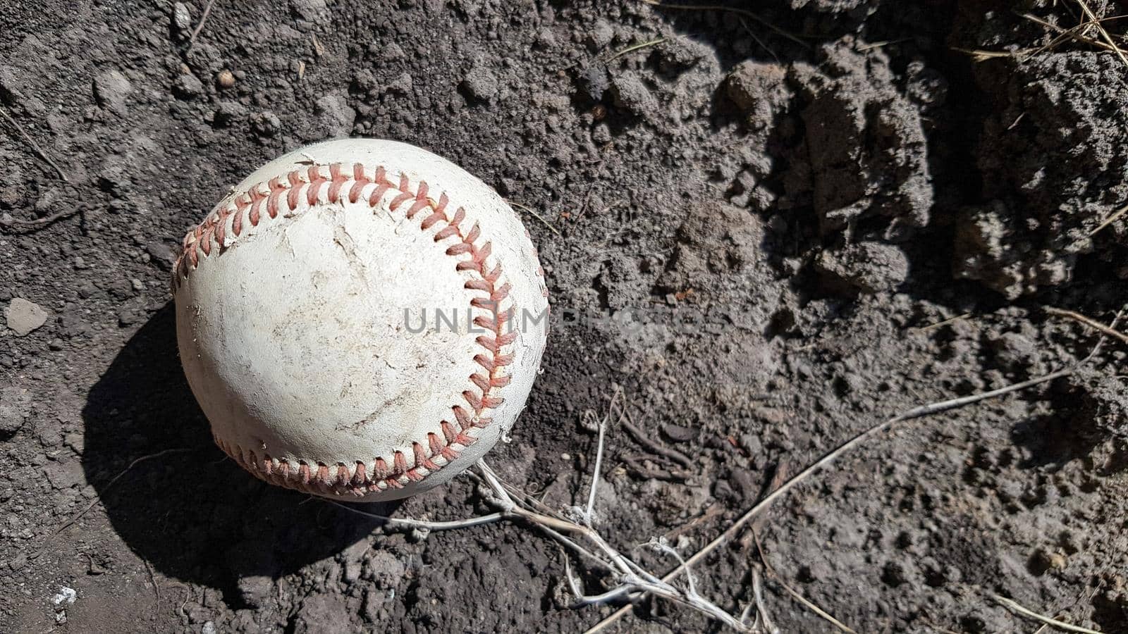 Closeup White leather textured baseball ball with red seams. Ball Outside Stadium Home Run Concept.