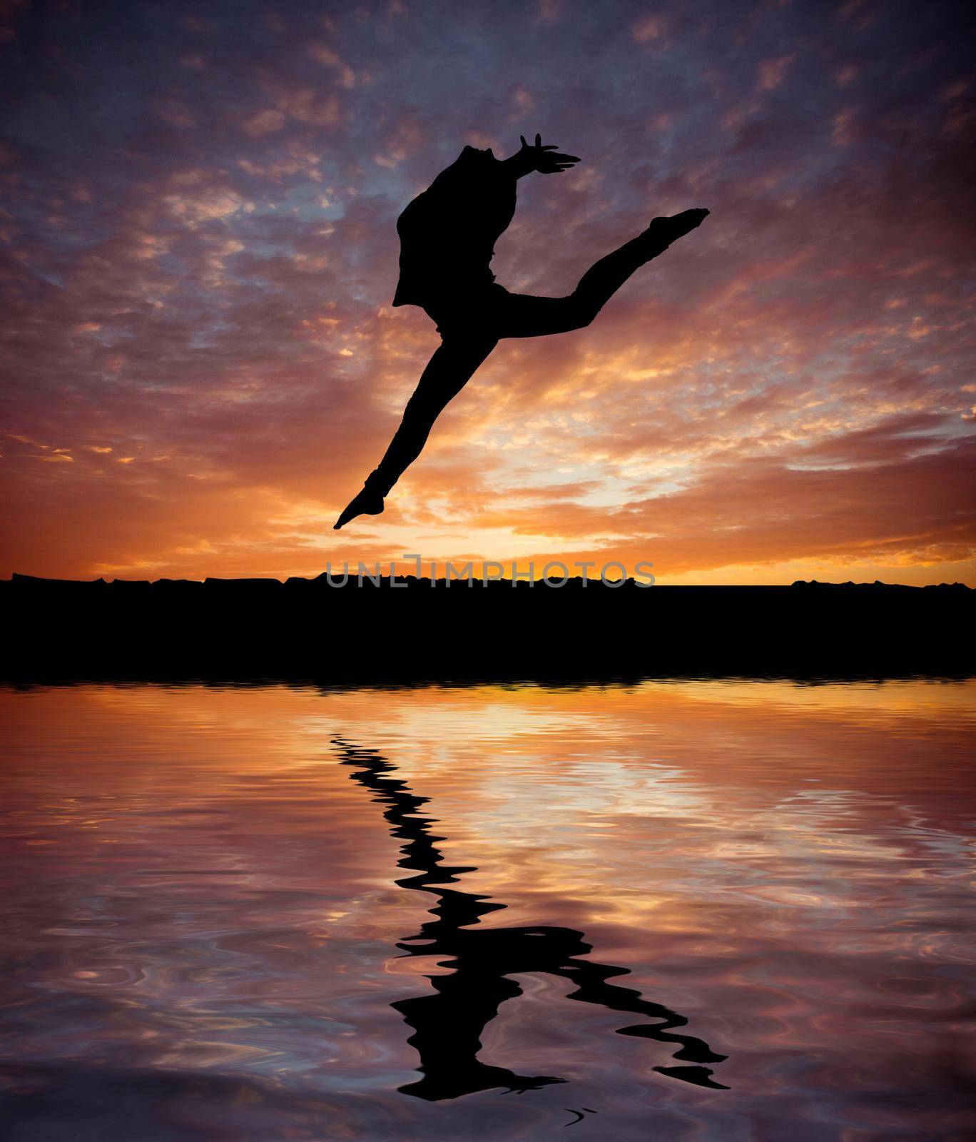 silhouette jumping gymnast on the background of beautiful sunset on the beach