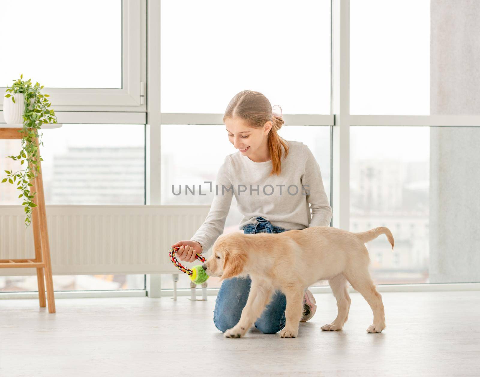 Girl playing with young dog by tan4ikk1