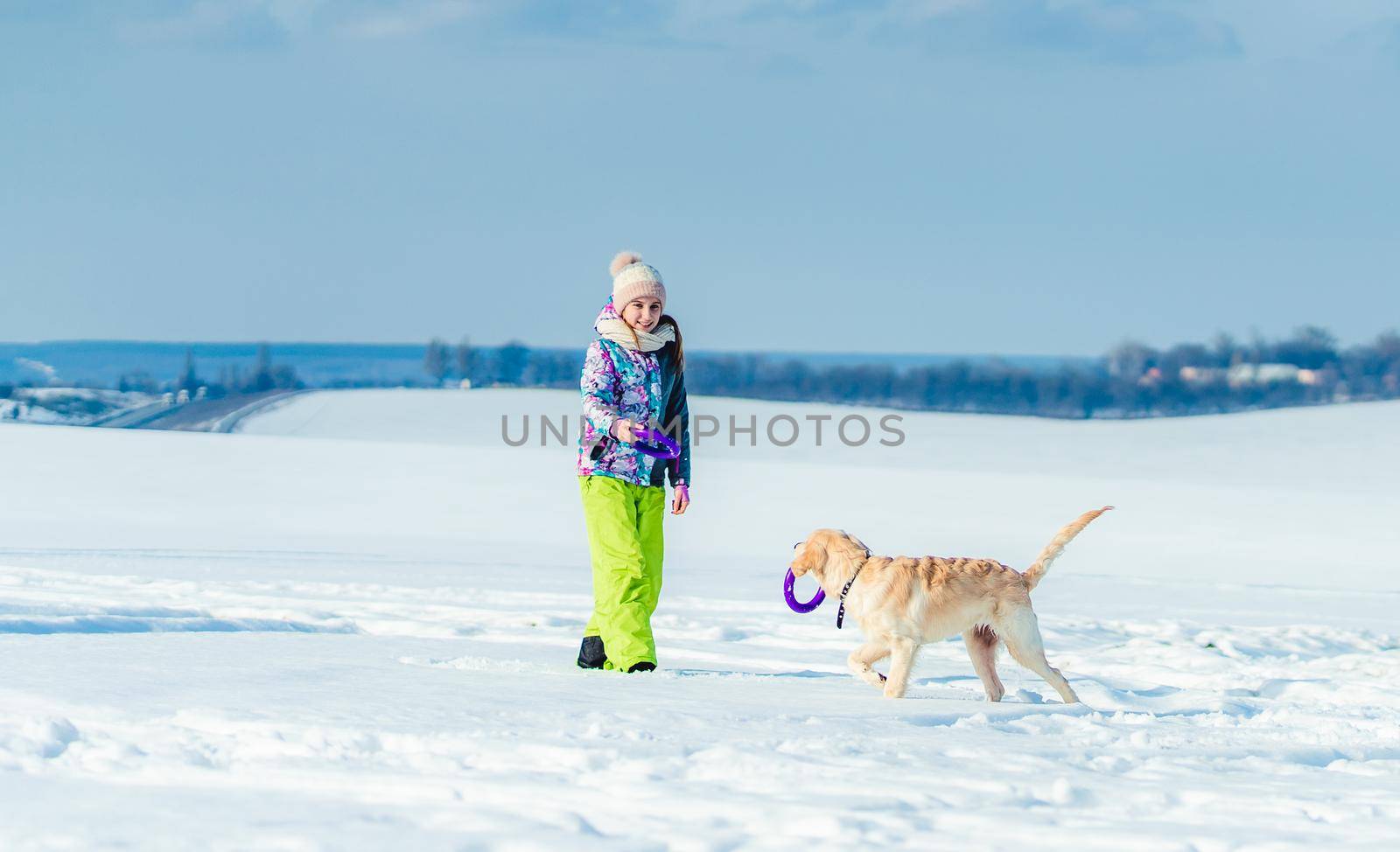 Girl running with dog in snow by tan4ikk1