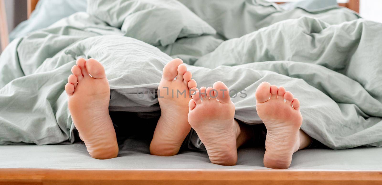 Feet of couple in the bed by tan4ikk1