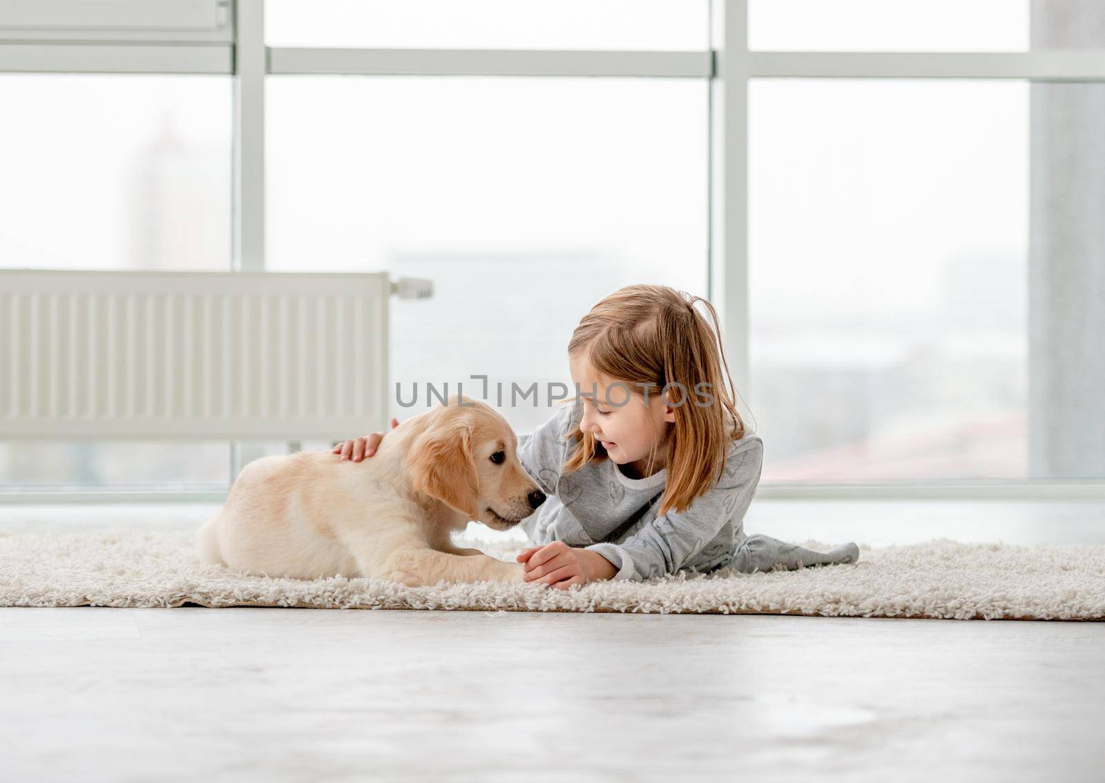 Little girl with young dog by tan4ikk1