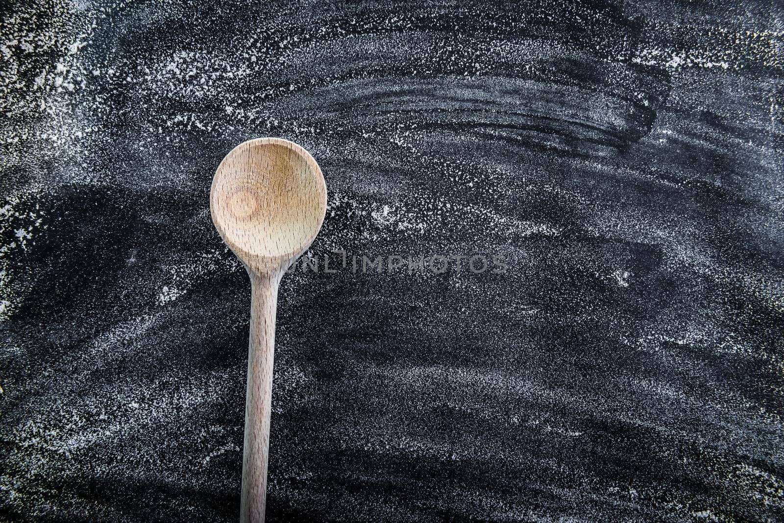 wooden spoon on a black textured table