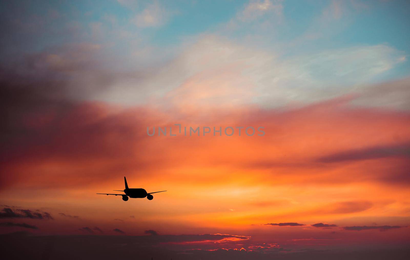 Airplane in the sky at sunset