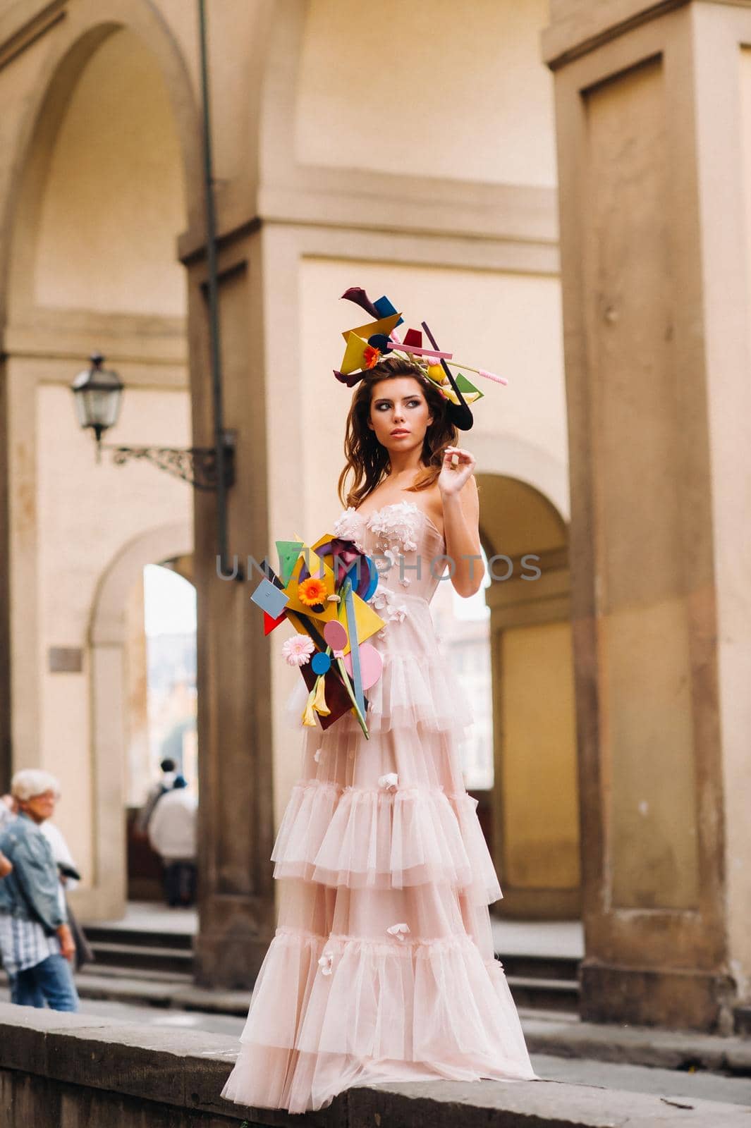 beautiful stylish girl model in a pink wedding dress photographed in Florence, holding an unusual bouquet, bride model with a bouquet in her hands, photo session of the bride in Florence