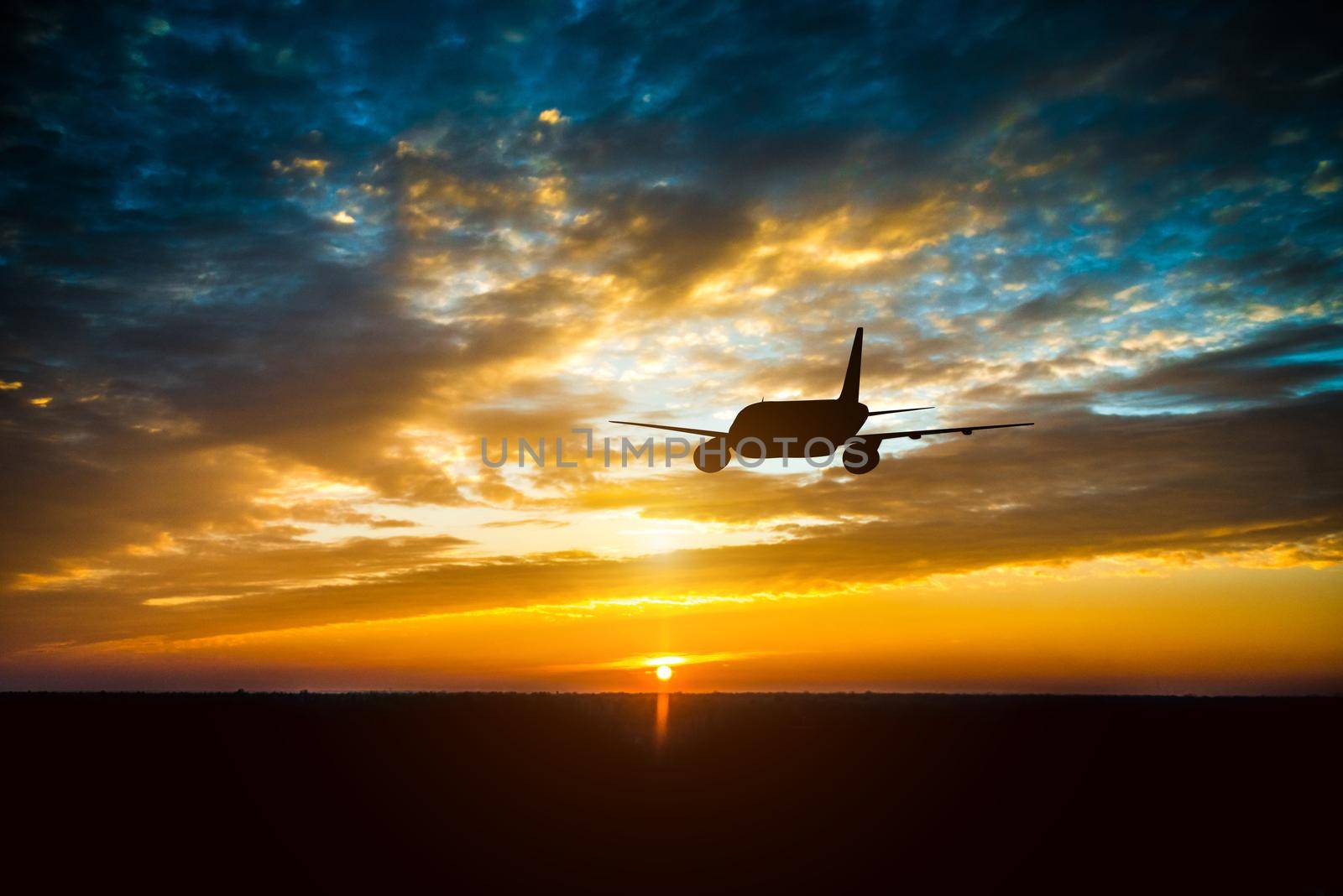 Airplane in the sky at sunset by tan4ikk1