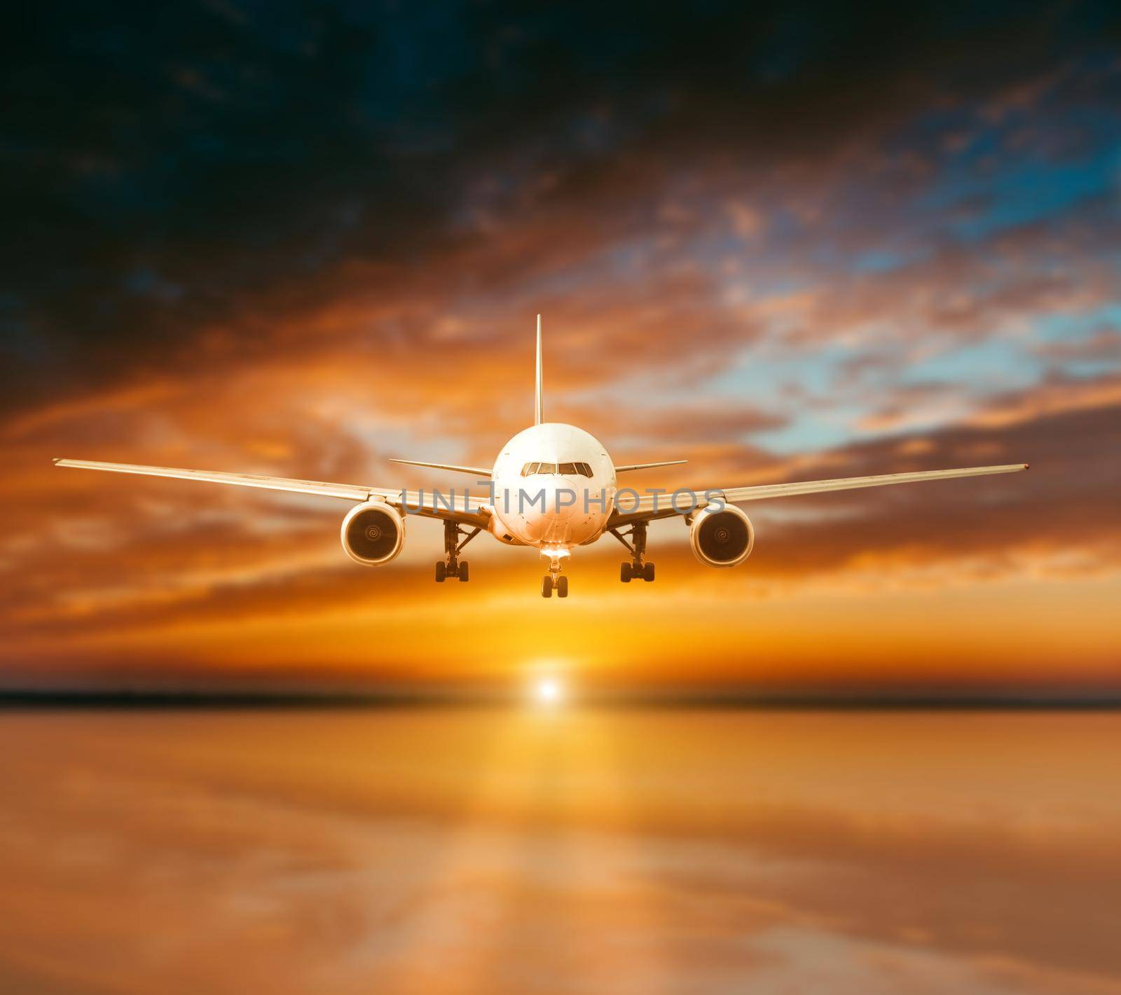 plane lands on the runway on a background of gorgeous sunsets