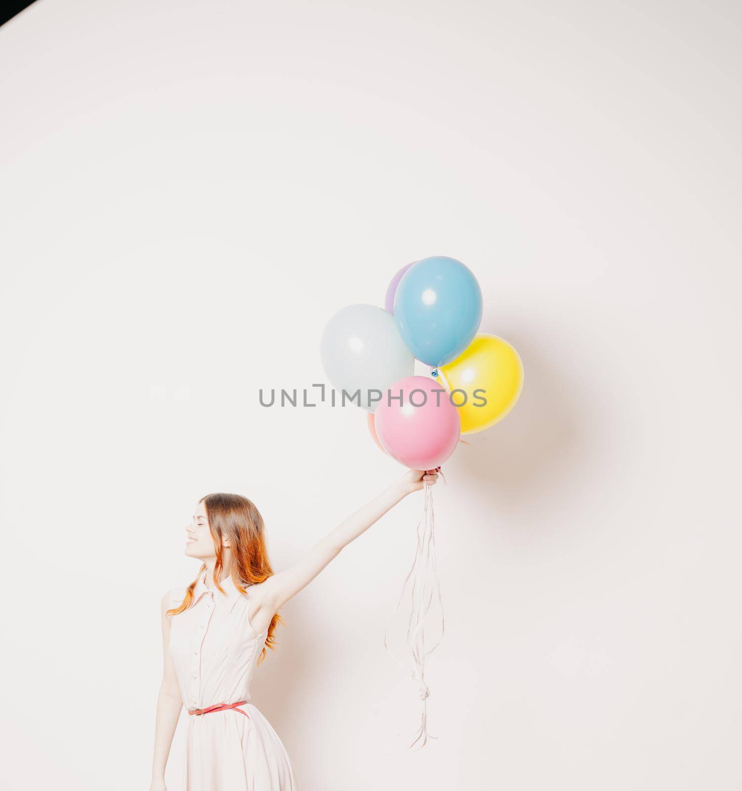 cheerful woman in a dress of colorful balloons by Vichizh