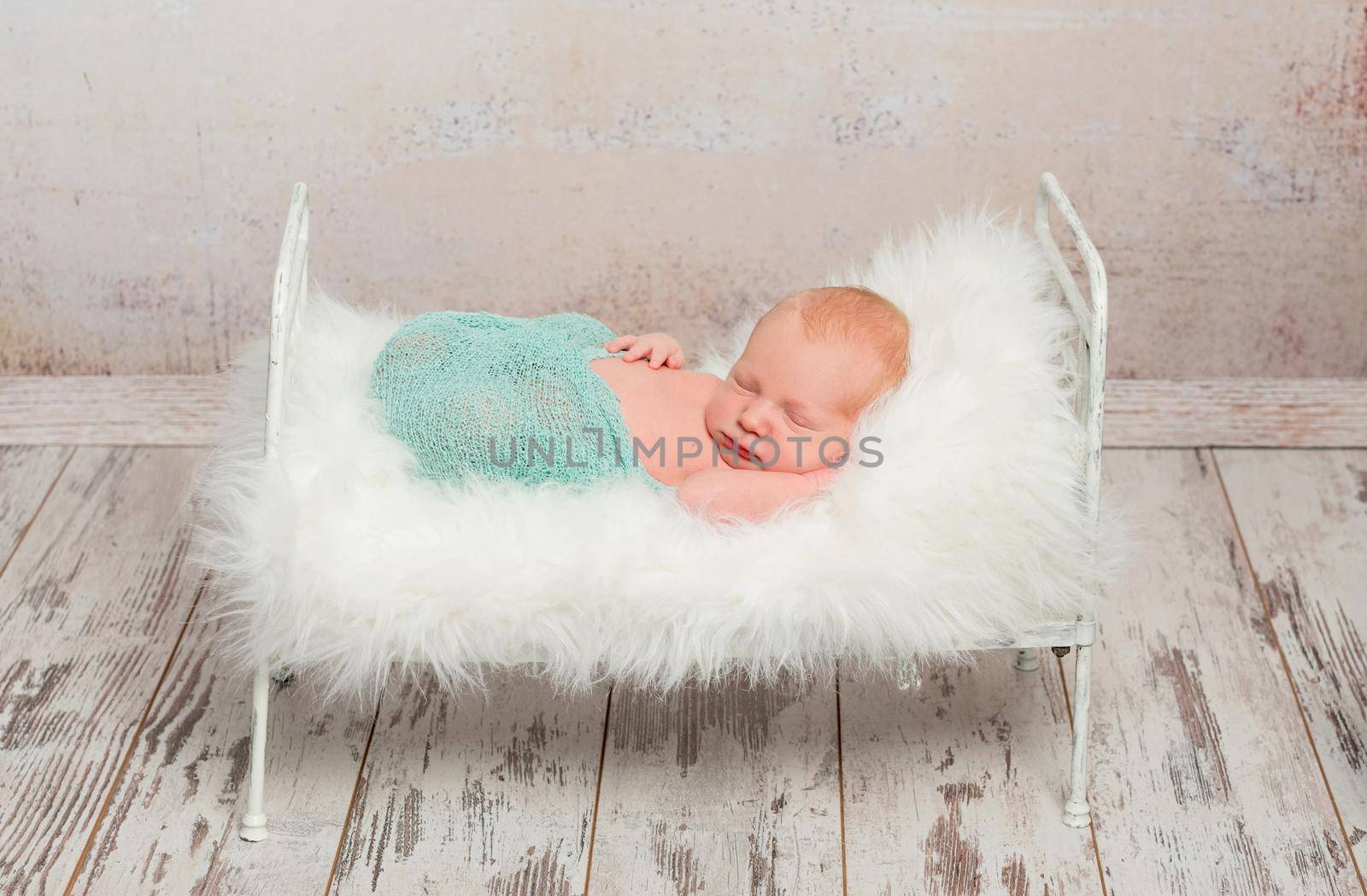 newborn sleeping on cot with white soft blanket by tan4ikk1