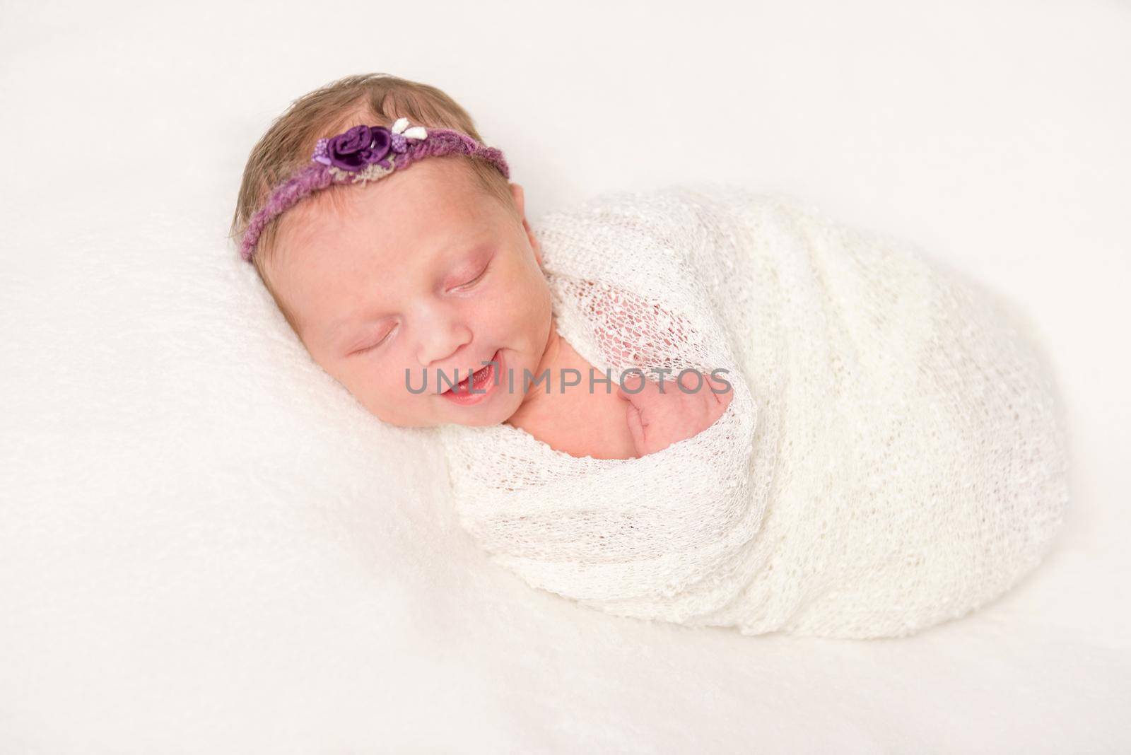 cute newborn in headband with flowers smiling asleep by tan4ikk1