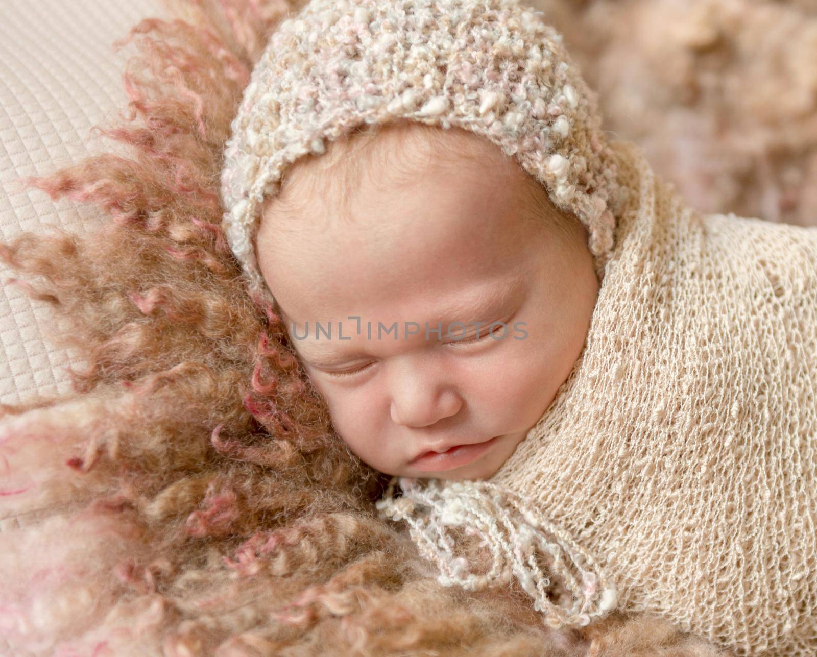 cute sleeping newborn baby in hat on fluffy blanket, closeup