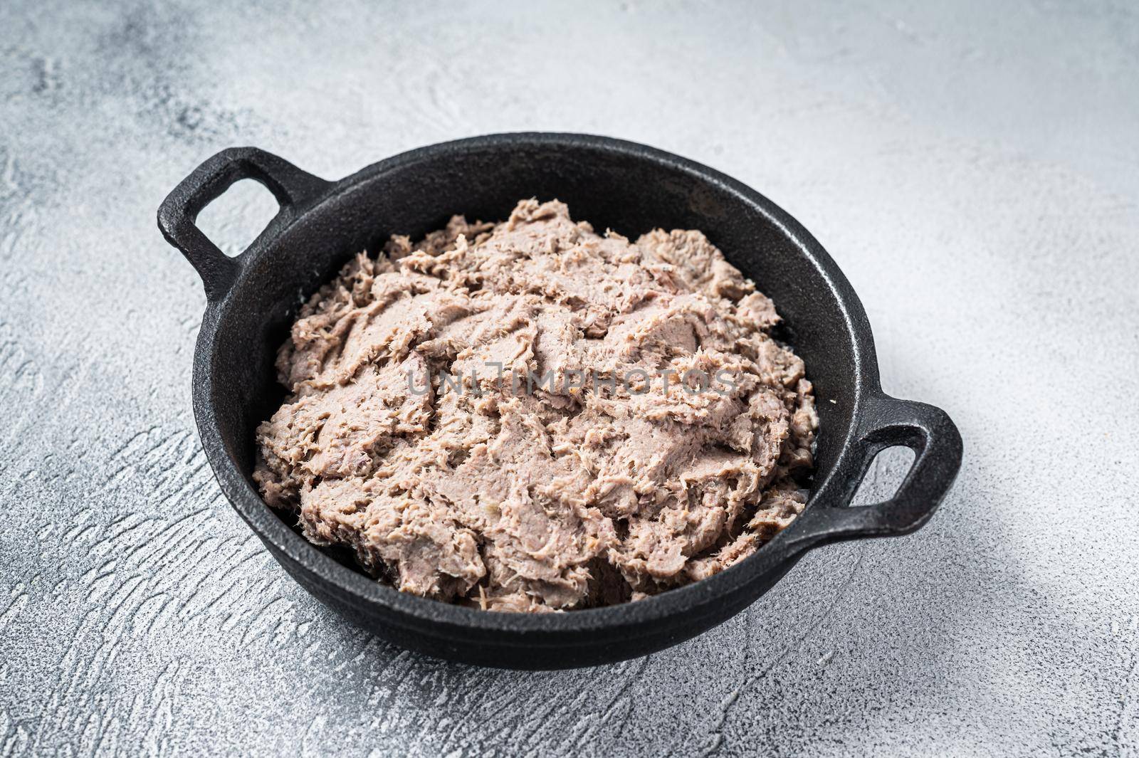 Duck pate Rillettes de Canard in a pan. White background. Top View. Copy space.