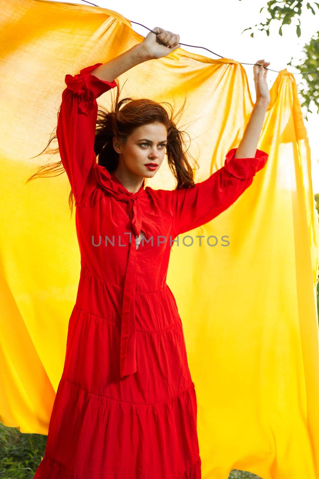 festively outdoors yellow cloth on the background of posing red dress. High quality photo