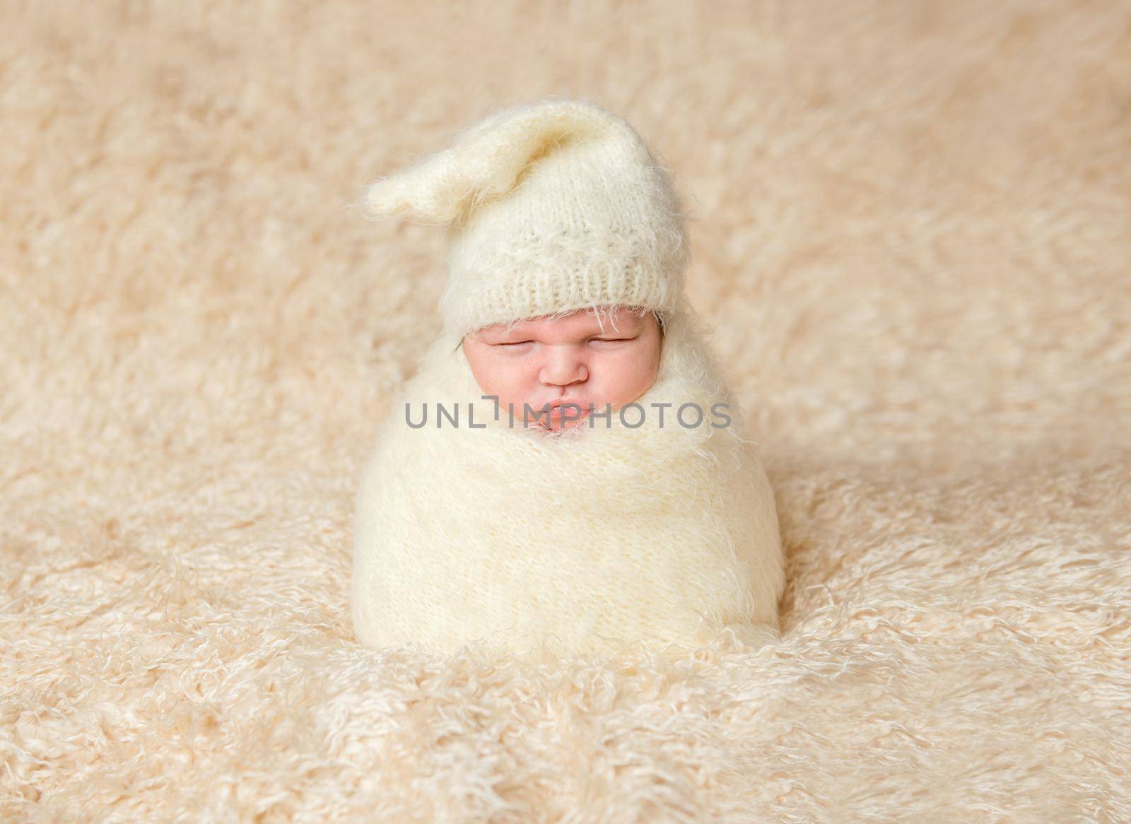 Infant in a funny pose, wrapped in blanket by tan4ikk1