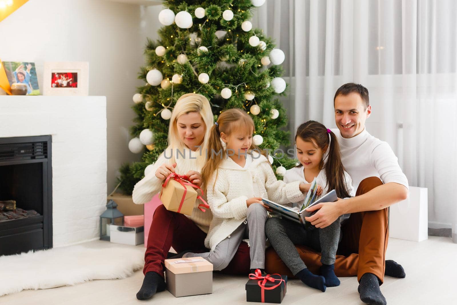 Happy family playing with Christmas gifts at home