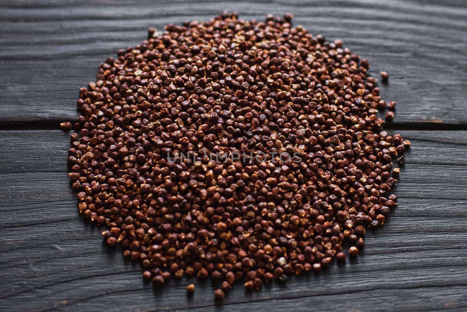 Black pepper grains, peppercorns seeds on a background close up macro
