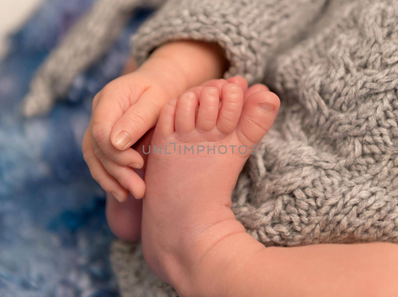 Perfection in details: adorable little toes and fingers of a newborn, closeup
