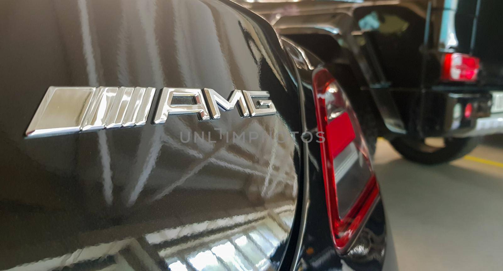AMG logo on the trunk. Concern Daimler AG. Production of powerful and sporty serial car models. AMG is the official tuning studio of Mercedes-Benz. Ukraine, Kiev - June 09, 2021