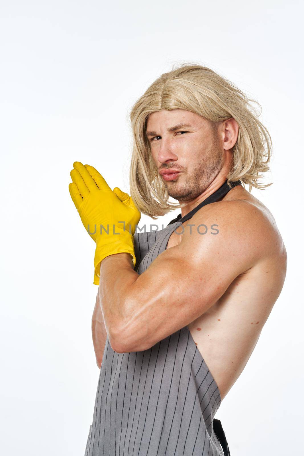 man in yellow rubber gloves in a woman's wig cleaning posing by Vichizh