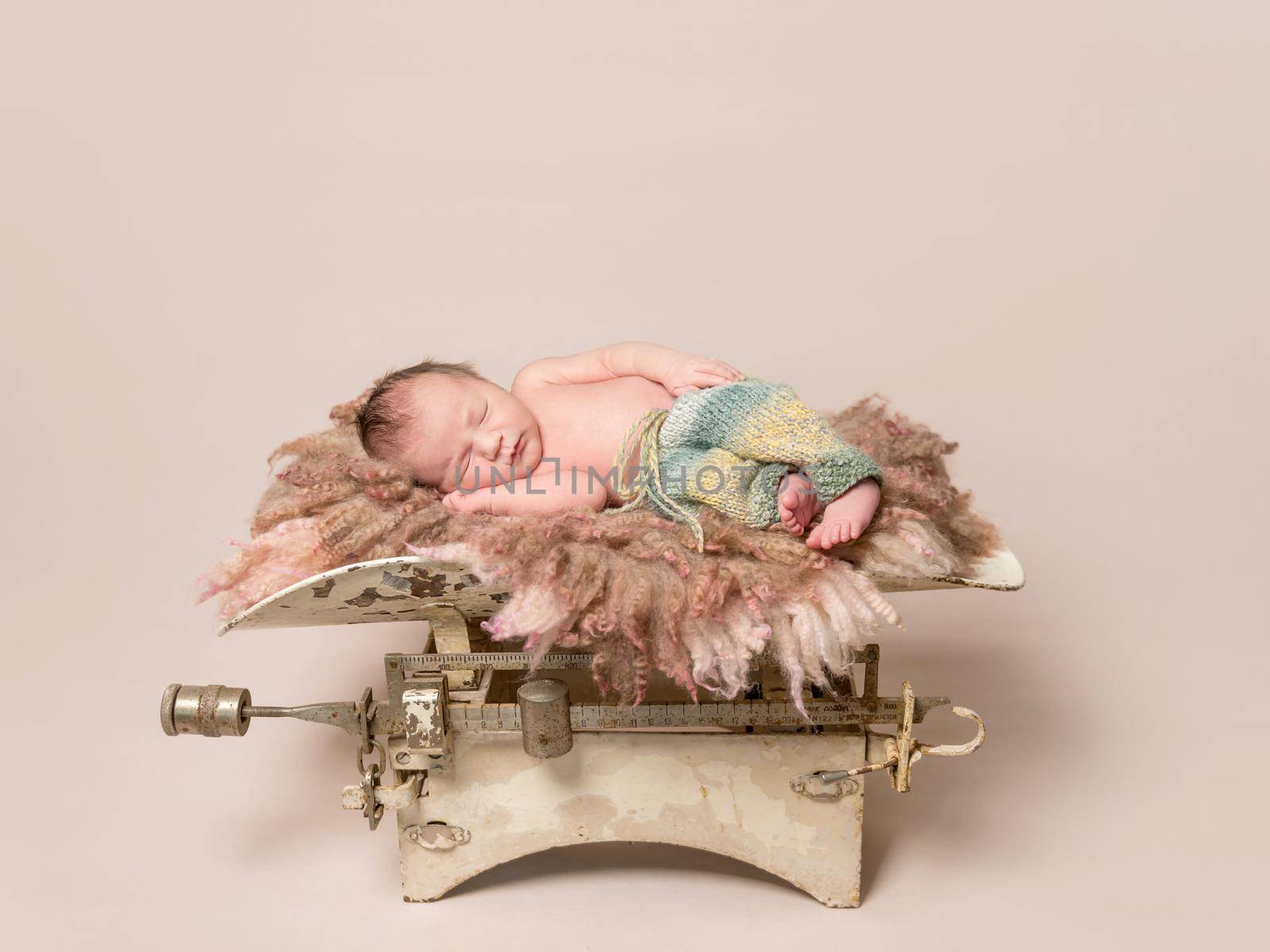 Lovely baby sleeping on old rusty scales by tan4ikk1