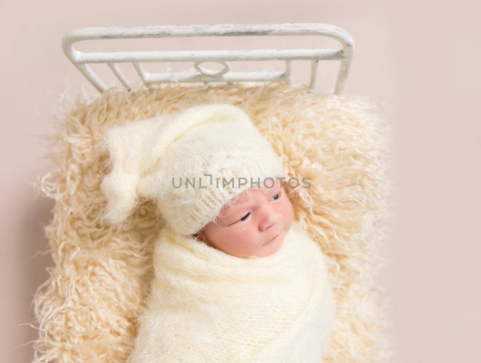 Kid resting covered with yellowish cover sheet by tan4ikk1