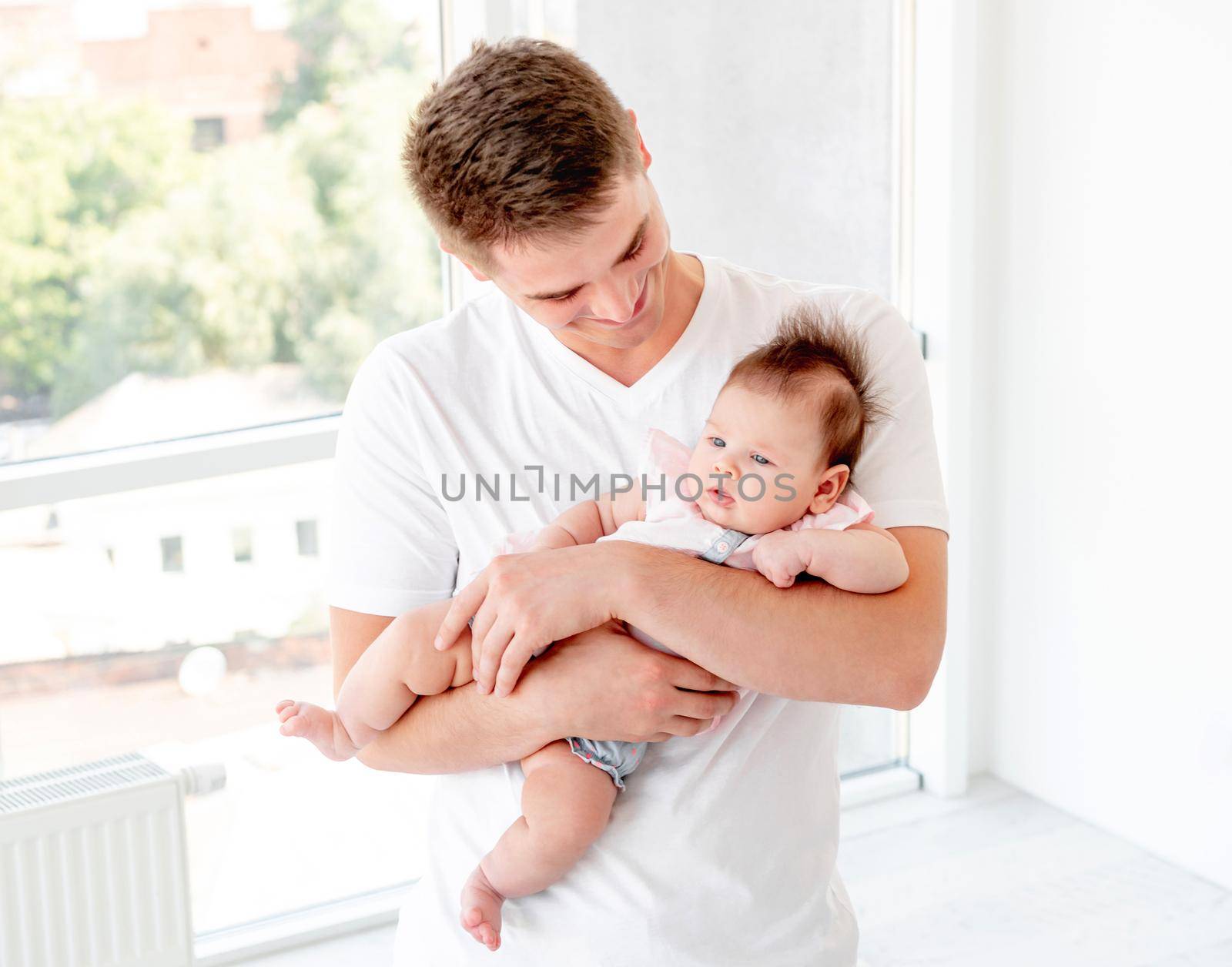 Father embracing infant by tan4ikk1