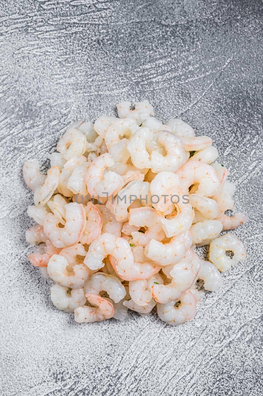 Peeled raw Shrimps, Prawns on a table. White background. top view.