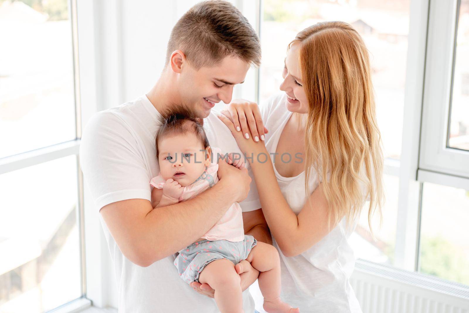 Young couple with beautiful baby at home