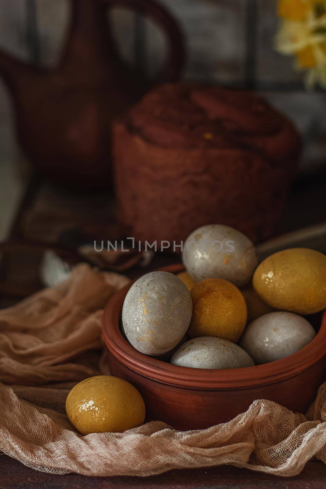 Natural dye for Easter eggs - turmeric and beetroot on vintage wooden background.