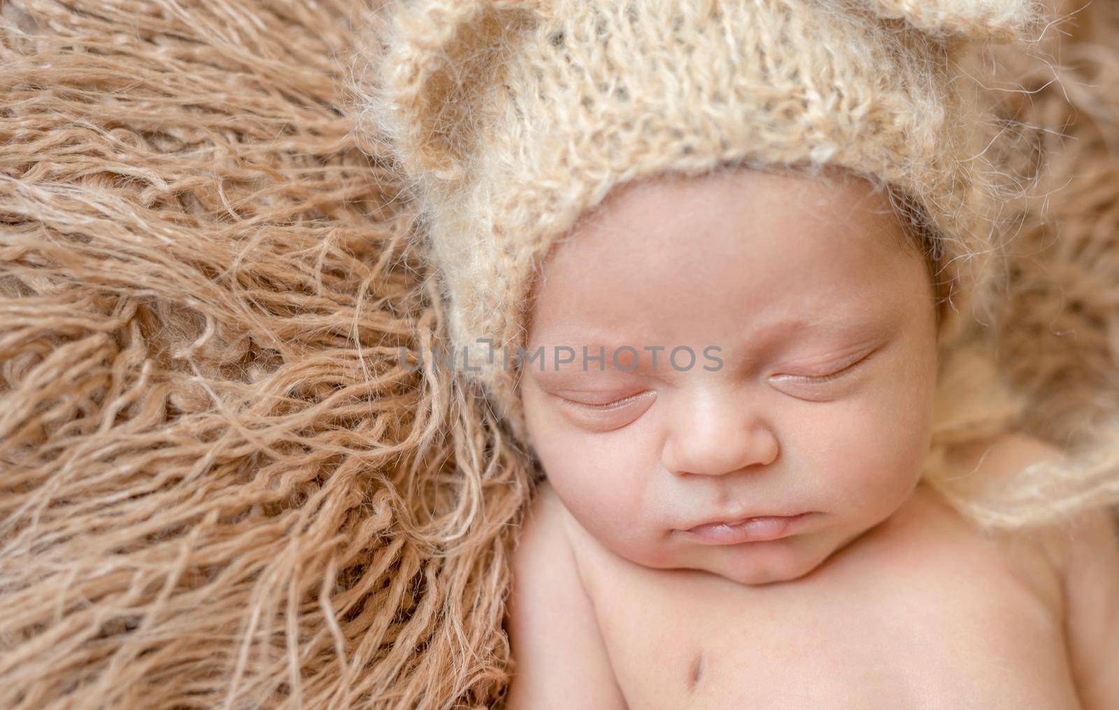 asleep smiling newborn baby in hat by tan4ikk1