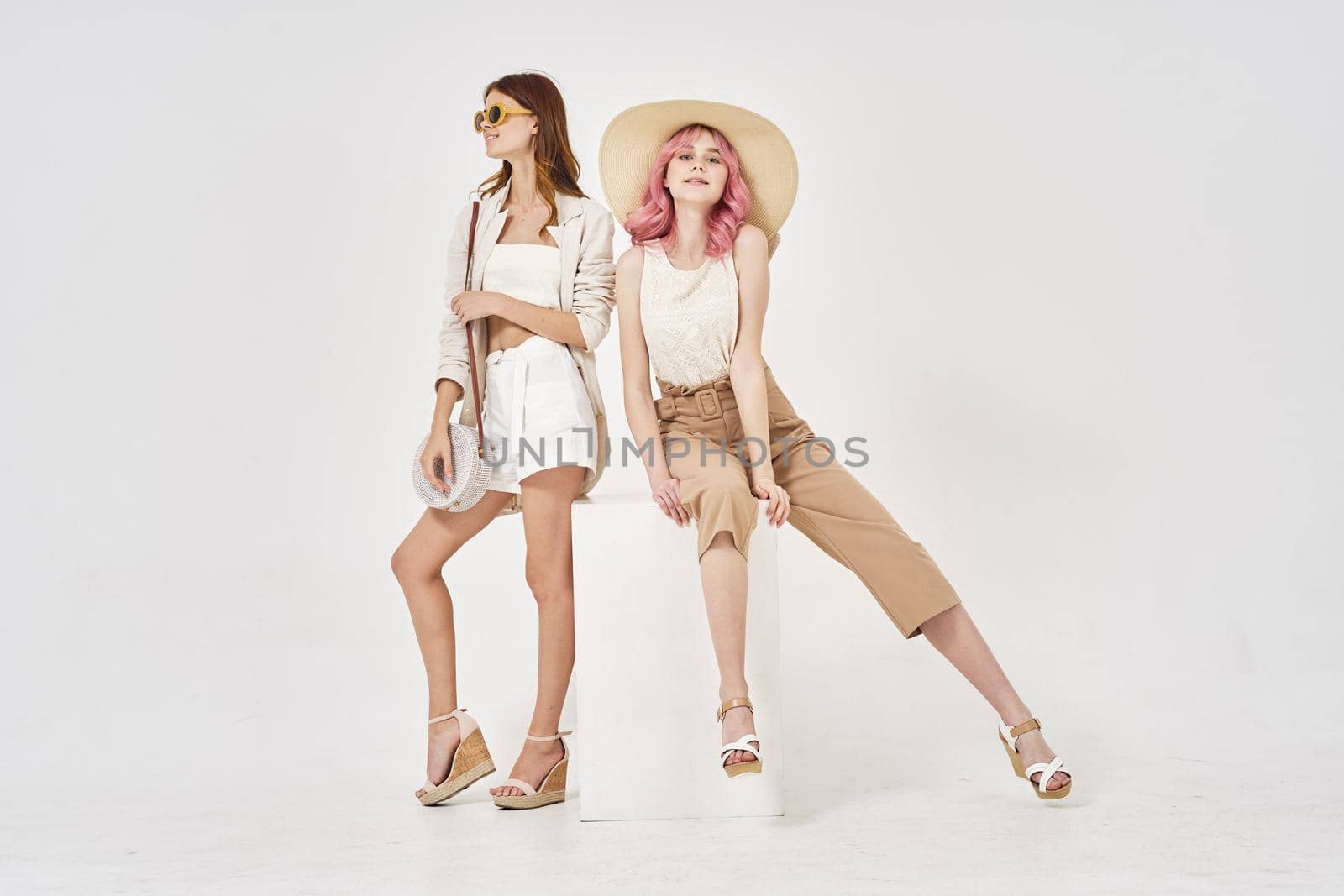 two women in fashionable clothes posing model decoration. High quality photo