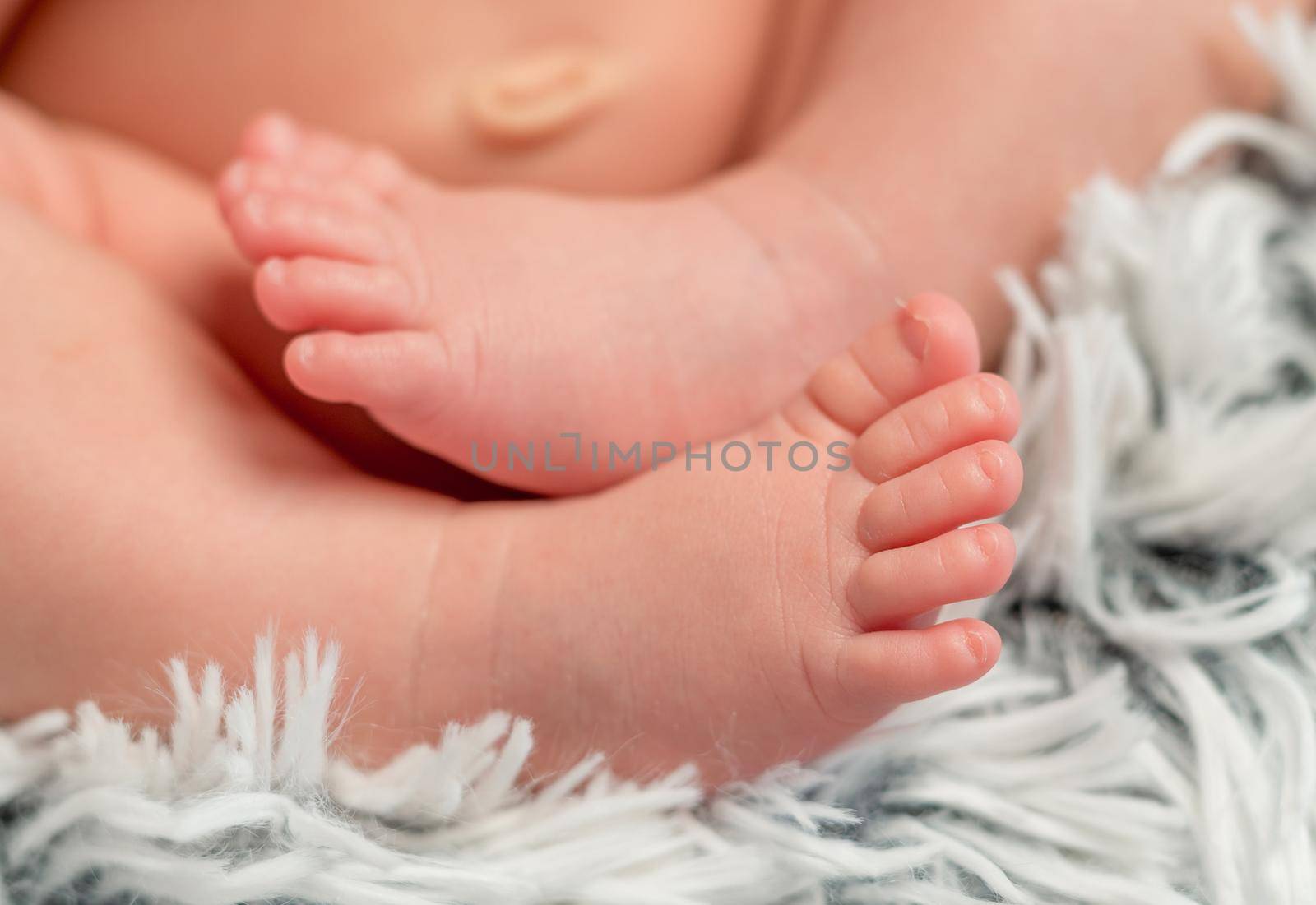 tender newborn baby feet with tiny toes, macro by tan4ikk1