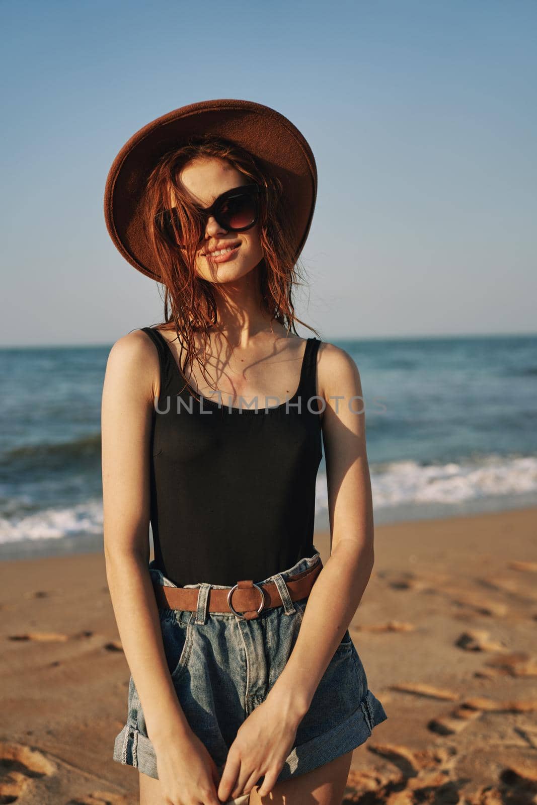 woman in trendy summer clothes by the ocean vacation sun. High quality photo