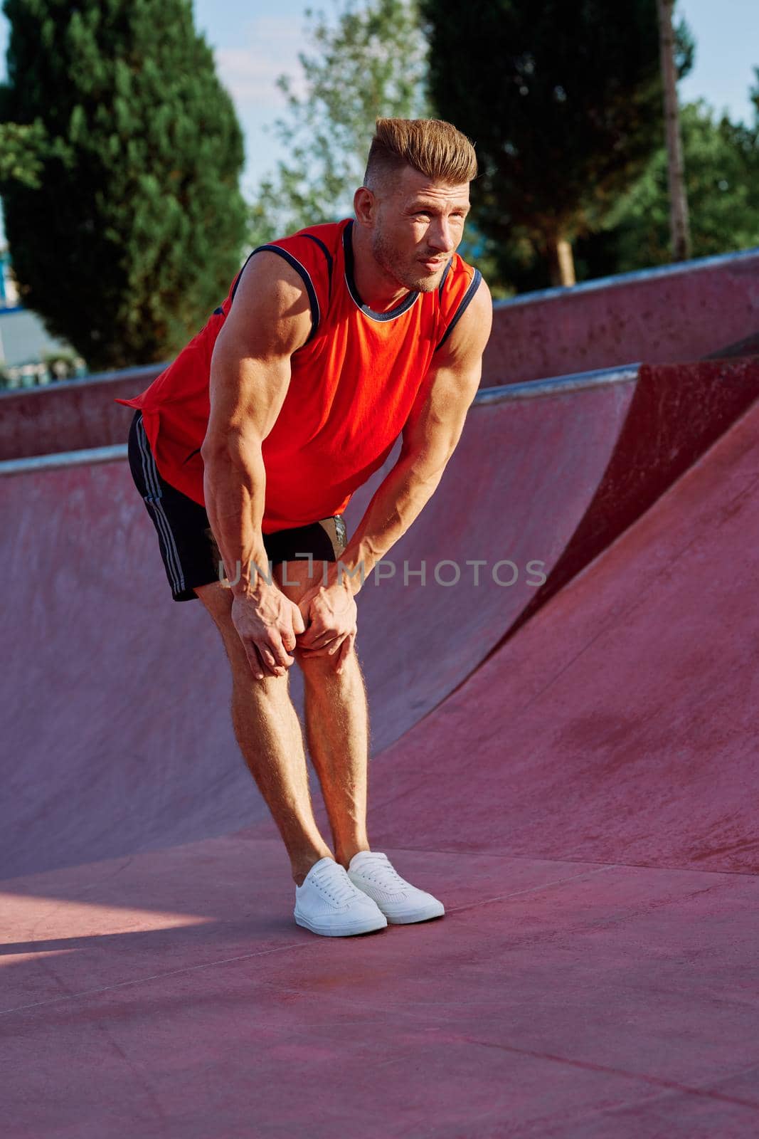 sports man on the playground in the park workout. High quality photo