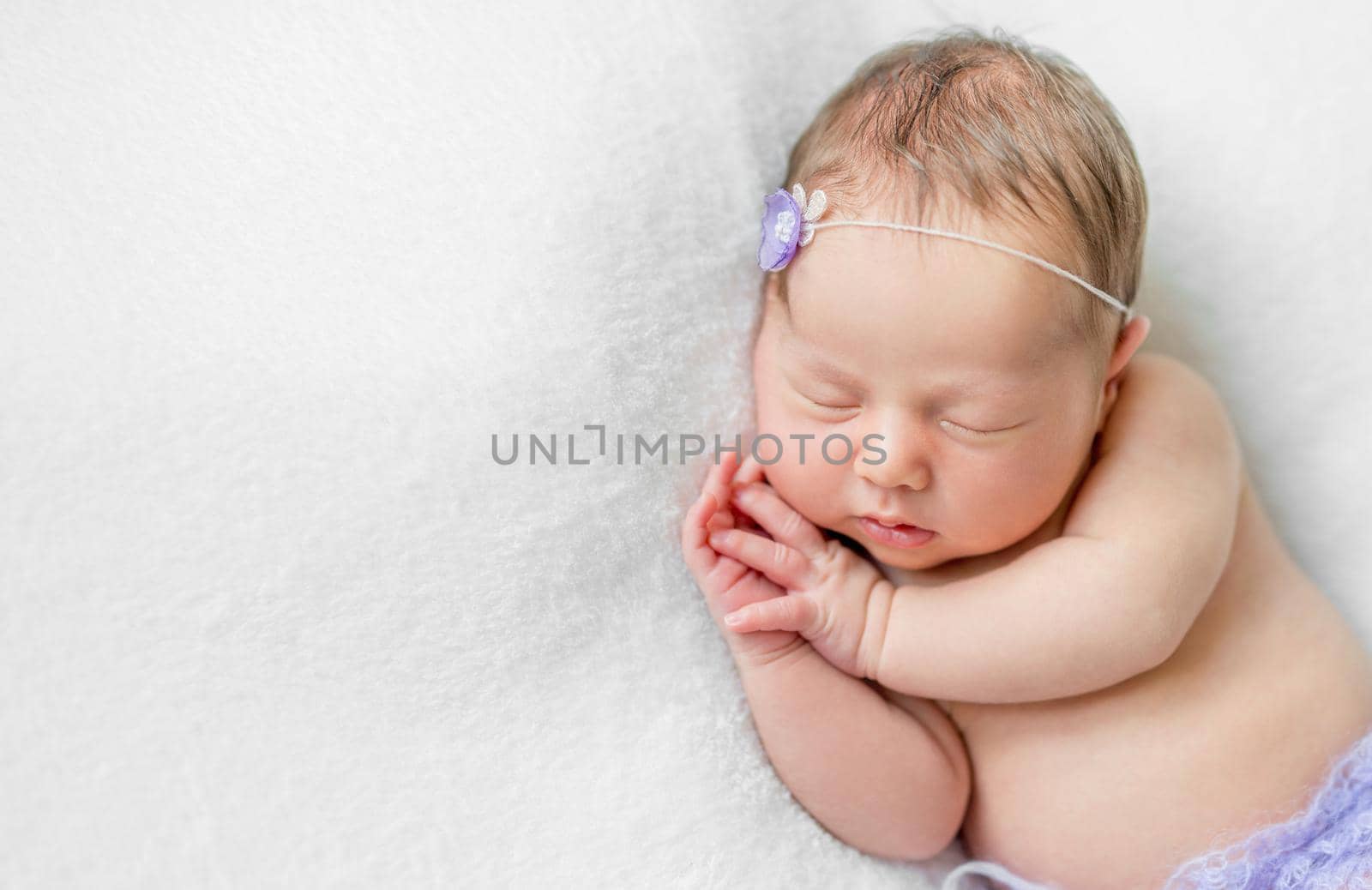 lovely newborn girl sleeping with hands under head, top view by tan4ikk1