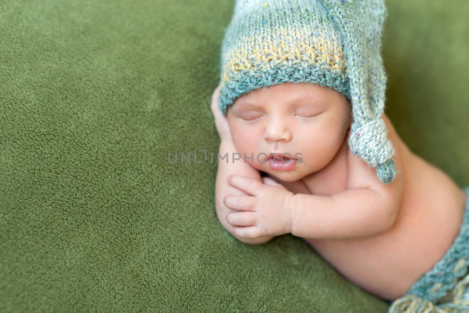 funny baby in knitted hat sleeping with opened mouth by tan4ikk1