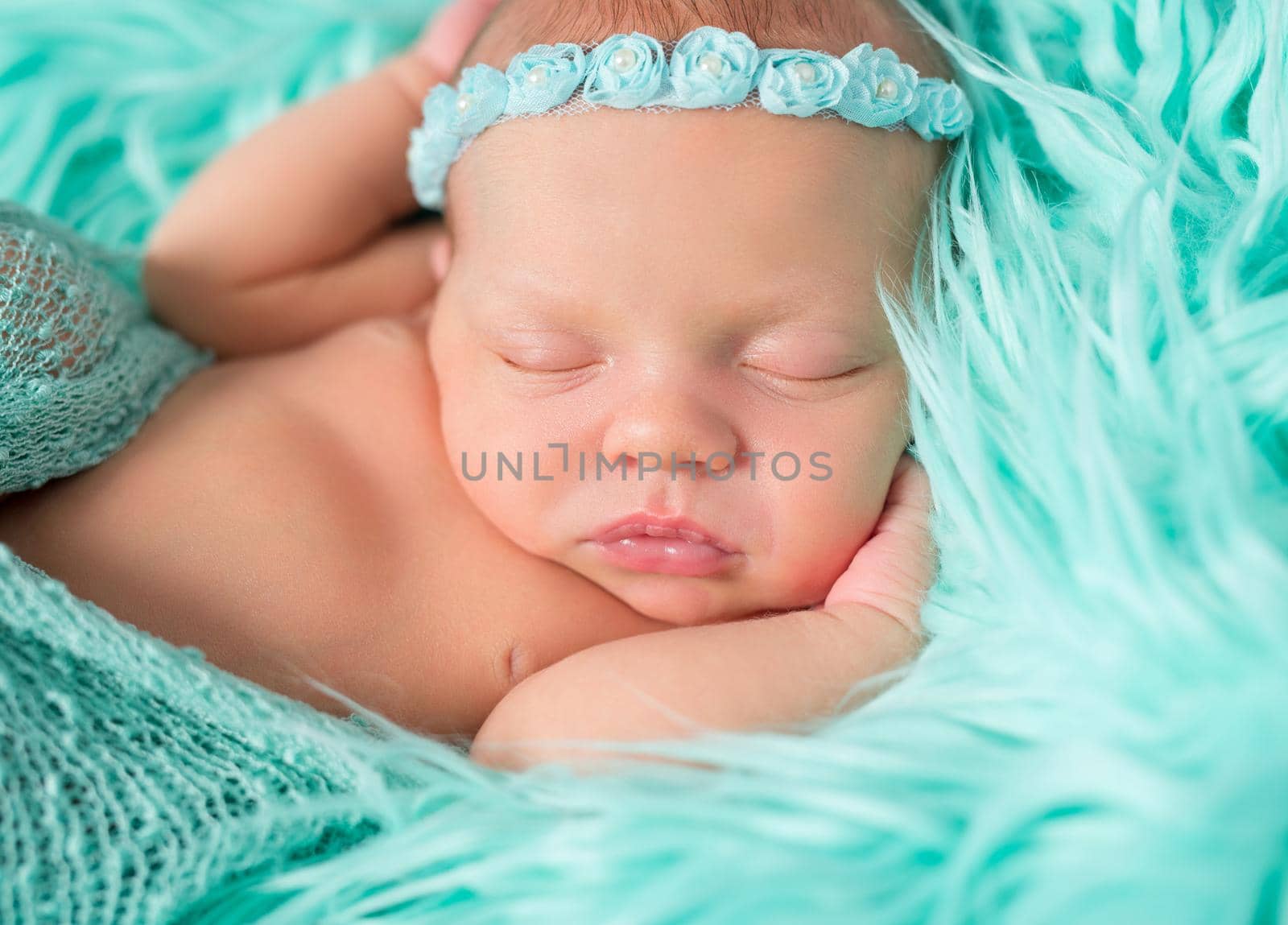 sweet sleeping newborn girl with flowers on headband by tan4ikk1