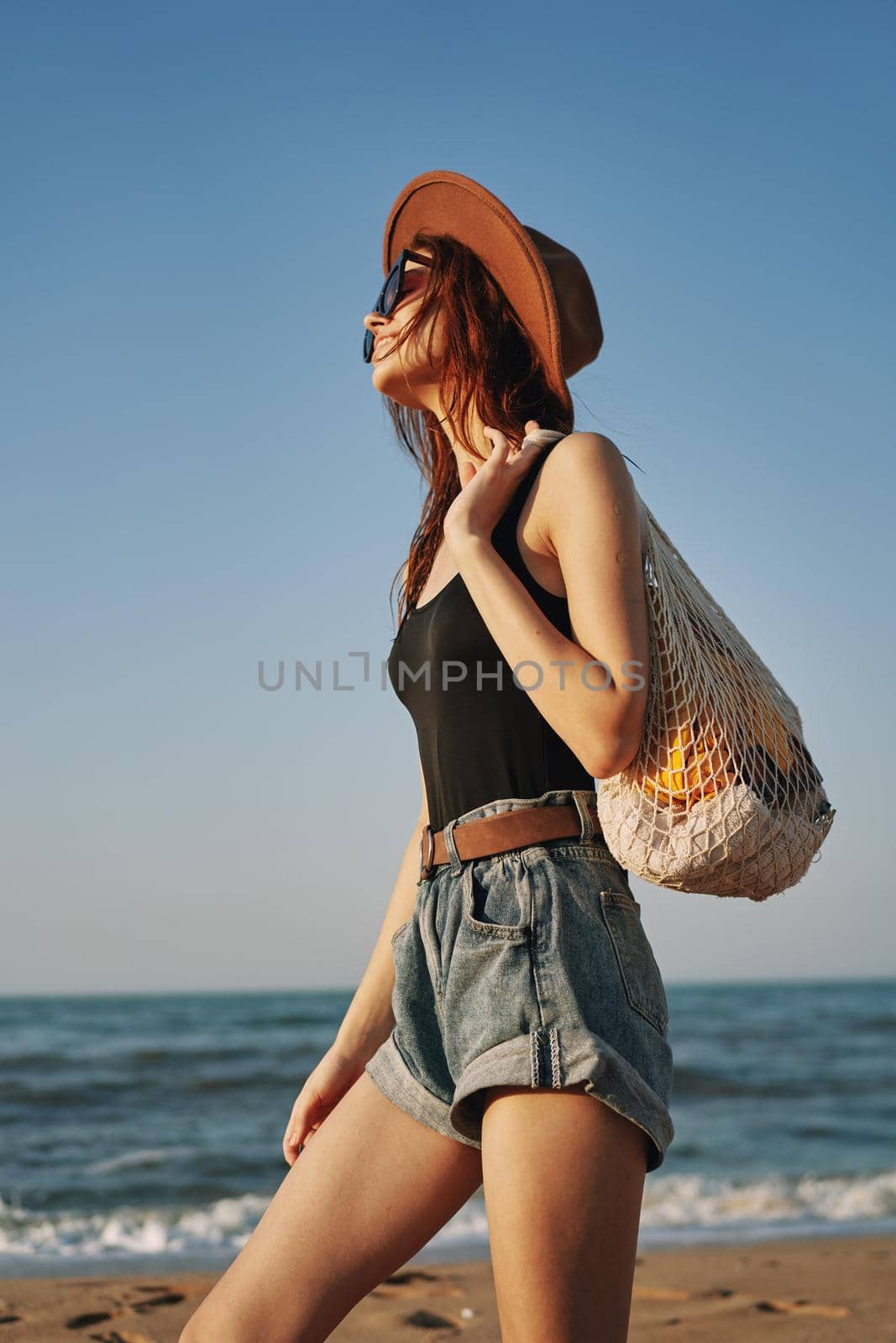 woman walking on the beach landscape sun fun lifestyle. High quality photo