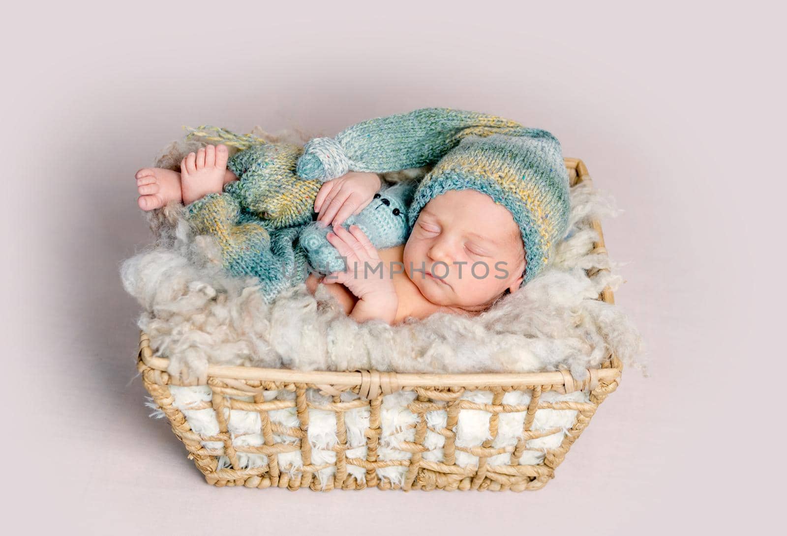 Newborn baby sleeps in a box on a fluffy background by tan4ikk1