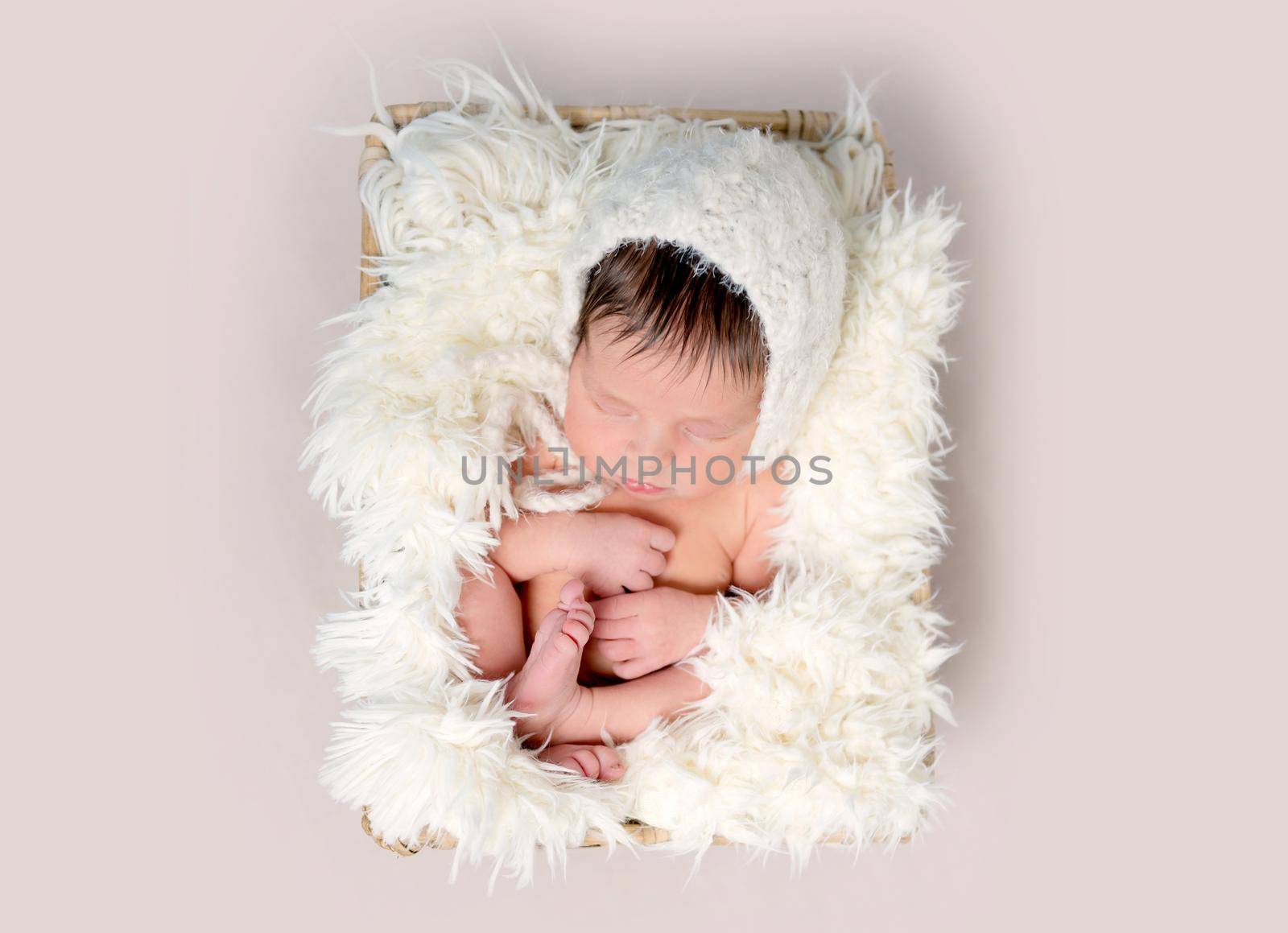 Newborn baby asleep on back with legs curled up by tan4ikk1