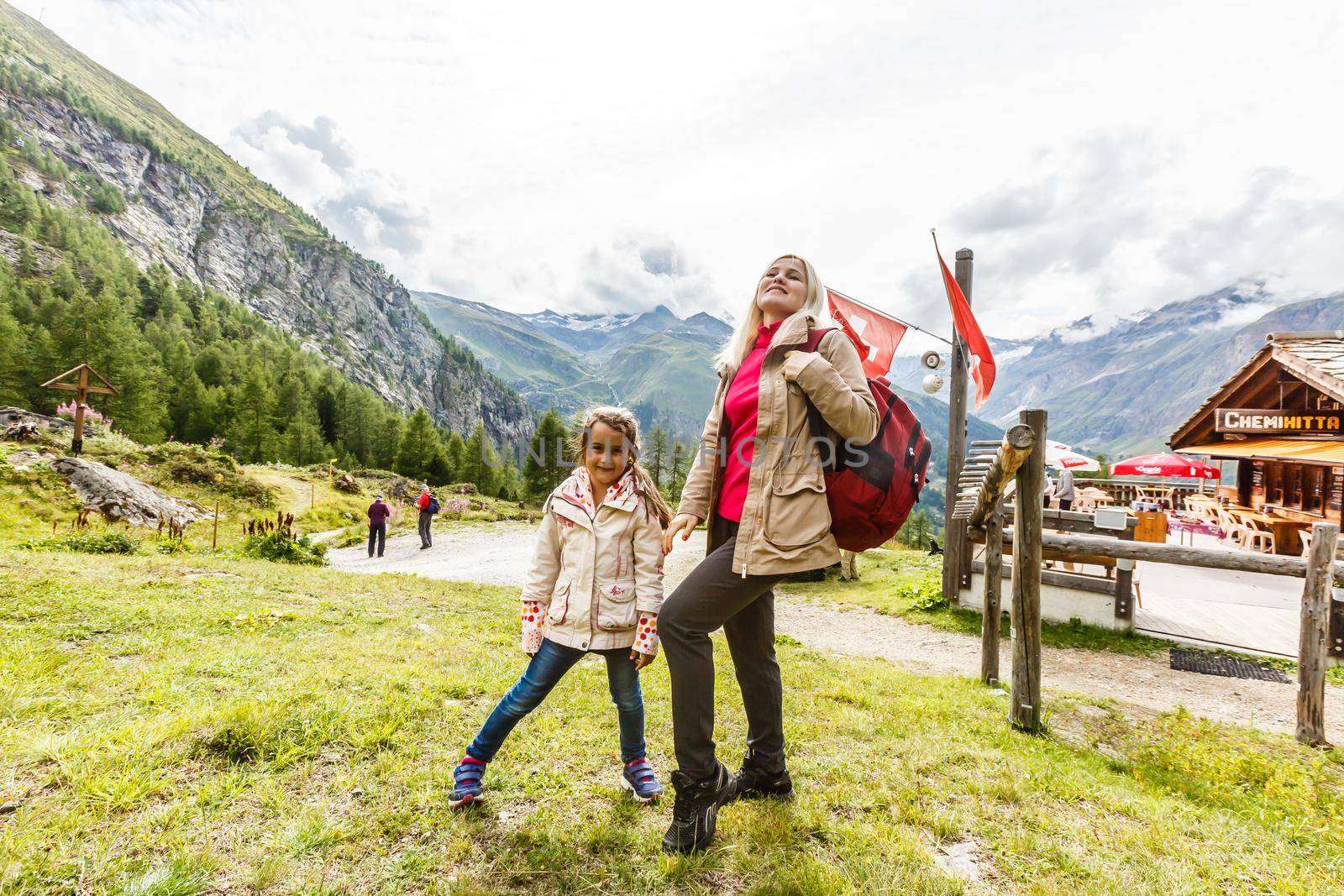 Mother and to children going for a walk in mountain surroundings.