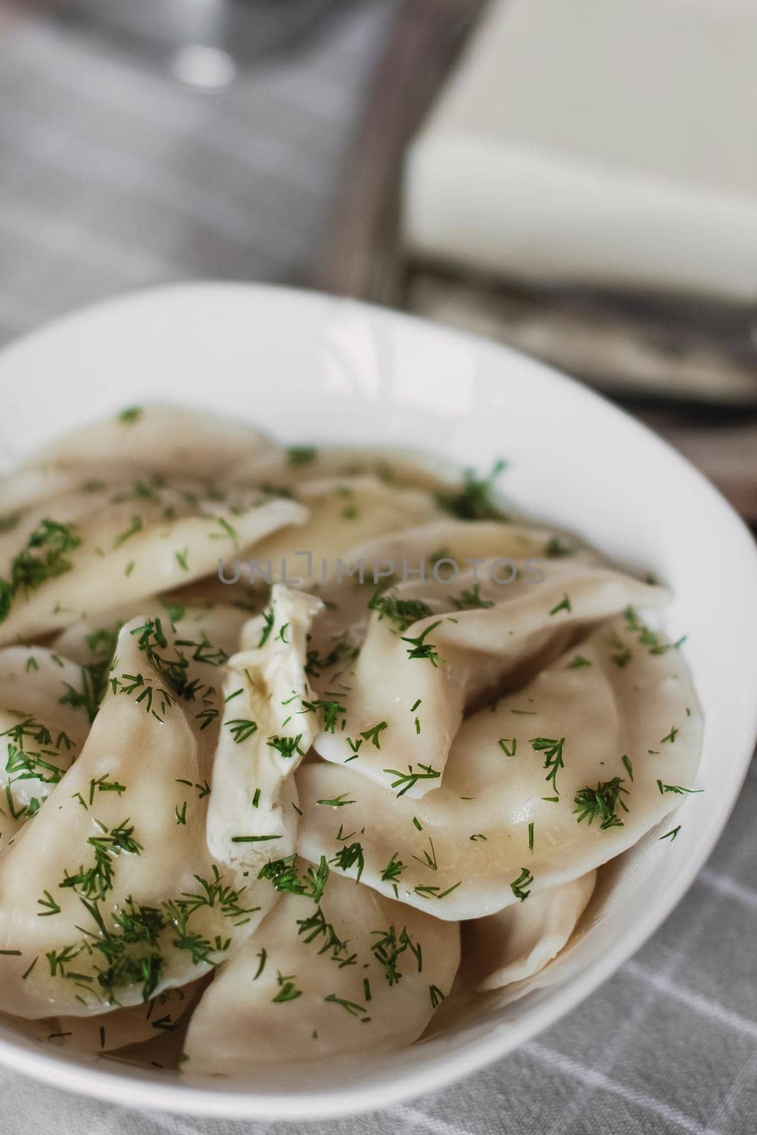Dumplings, filled with potatoes and served with butter and fennel. Varenyky, vareniki, pierogi, pyrohy. Dumplings with filling