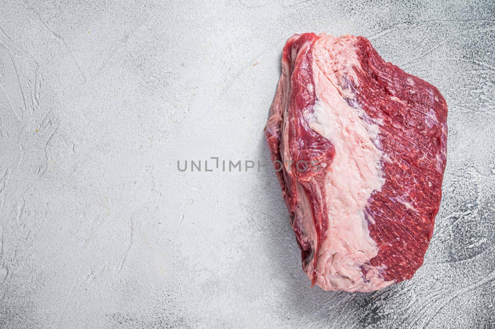Raw Round beef meat cut on a butcher table. White background. Top view. Copy space by Composter