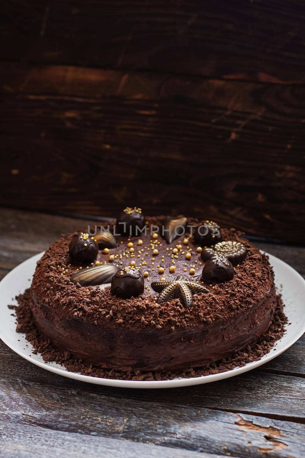 Plate with slice of tasty homemade chocolate cake on table.