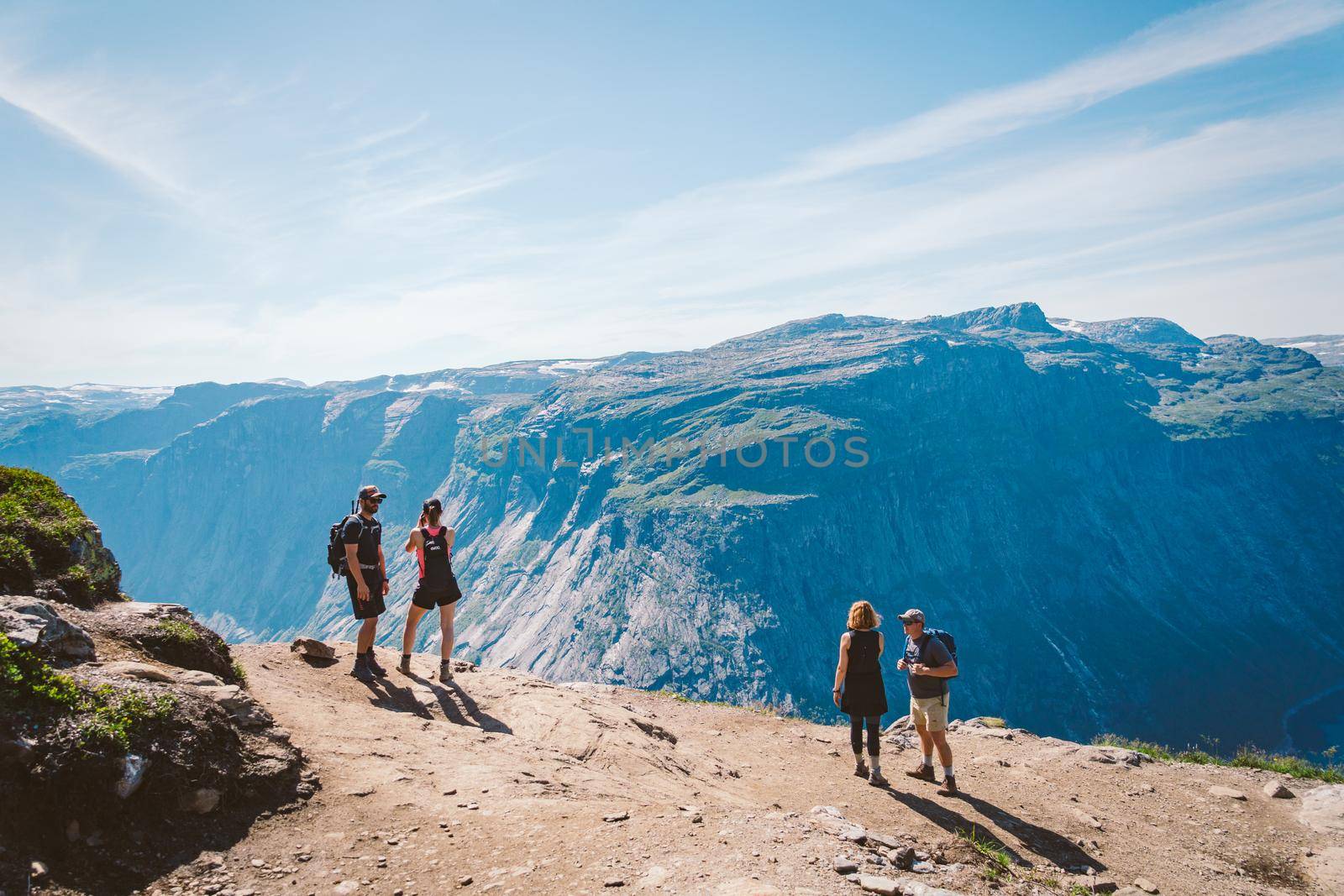 July 26, 2019. Norway tourist route on the trolltunga. People tourists go hiking in the mountains of Norway in fine sunny weather to thetrolltunga. Hiking backpack theme by Tomashevska