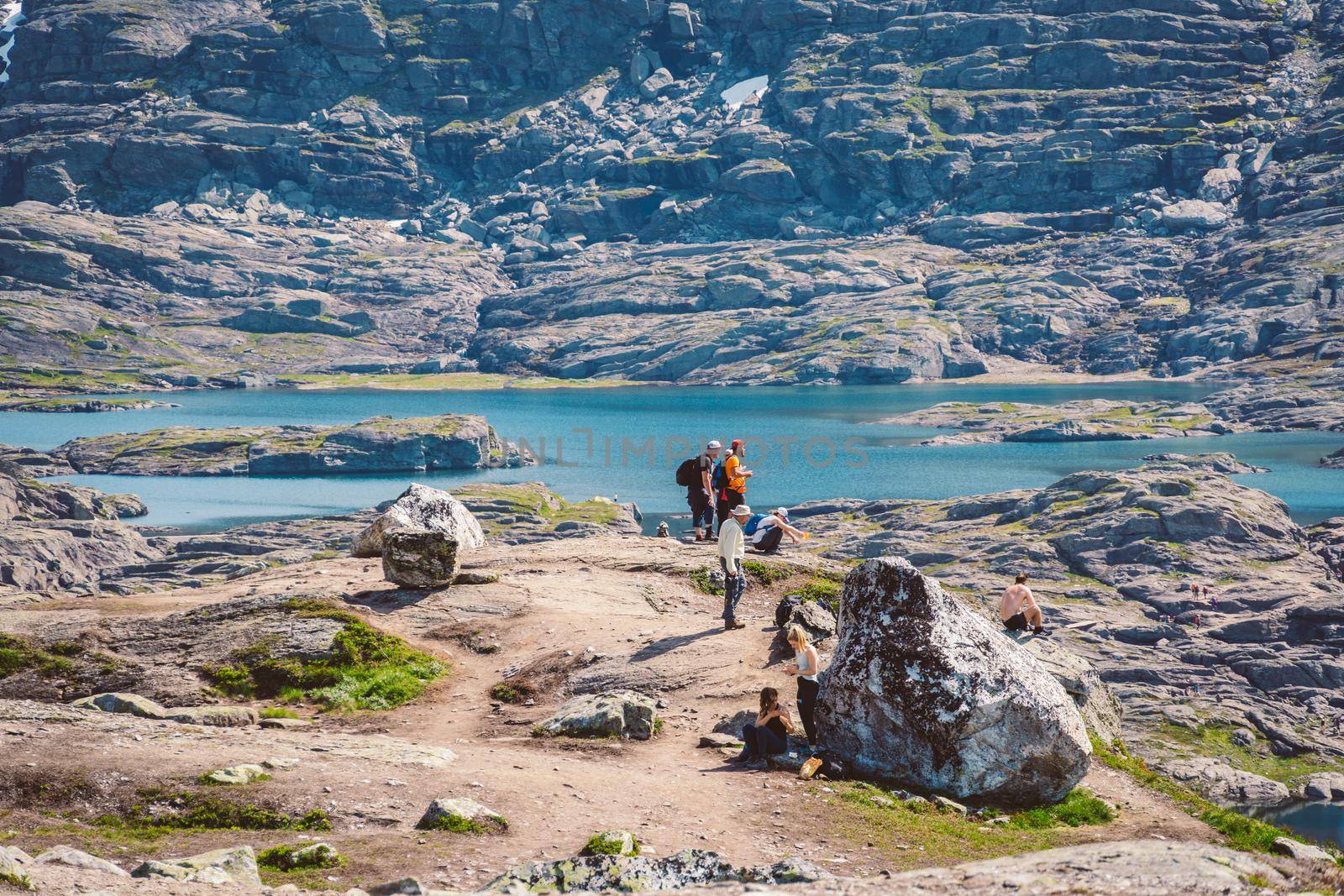 July 26, 2019. Norway tourist route on the trolltunga. People tourists go hiking in the mountains of Norway in fine sunny weather to thetrolltunga. Hiking backpack theme.