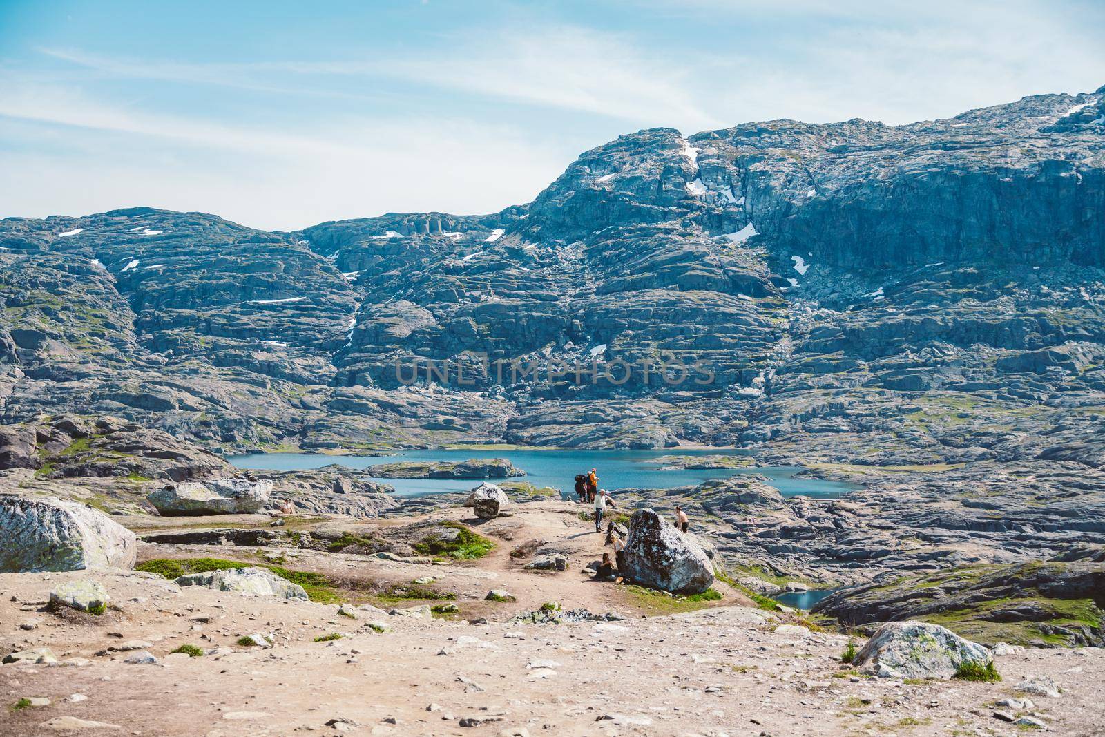 July 26, 2019. Norway tourist route on the trolltunga. People tourists go hiking in the mountains of Norway in fine sunny weather to thetrolltunga. Hiking backpack theme by Tomashevska