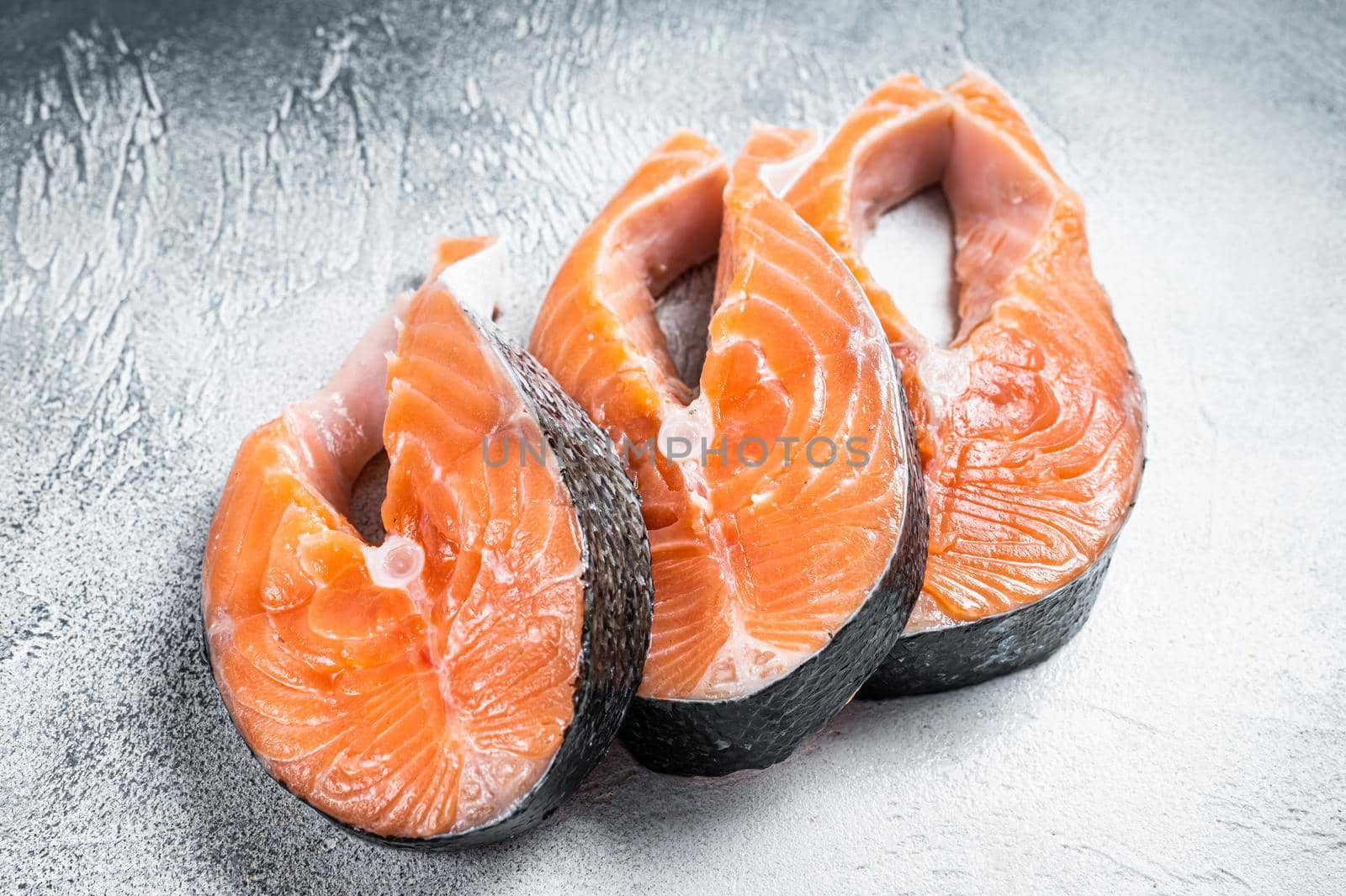 Salmon or trout steaks, raw fish prepared for cooking. White background. Top view by Composter
